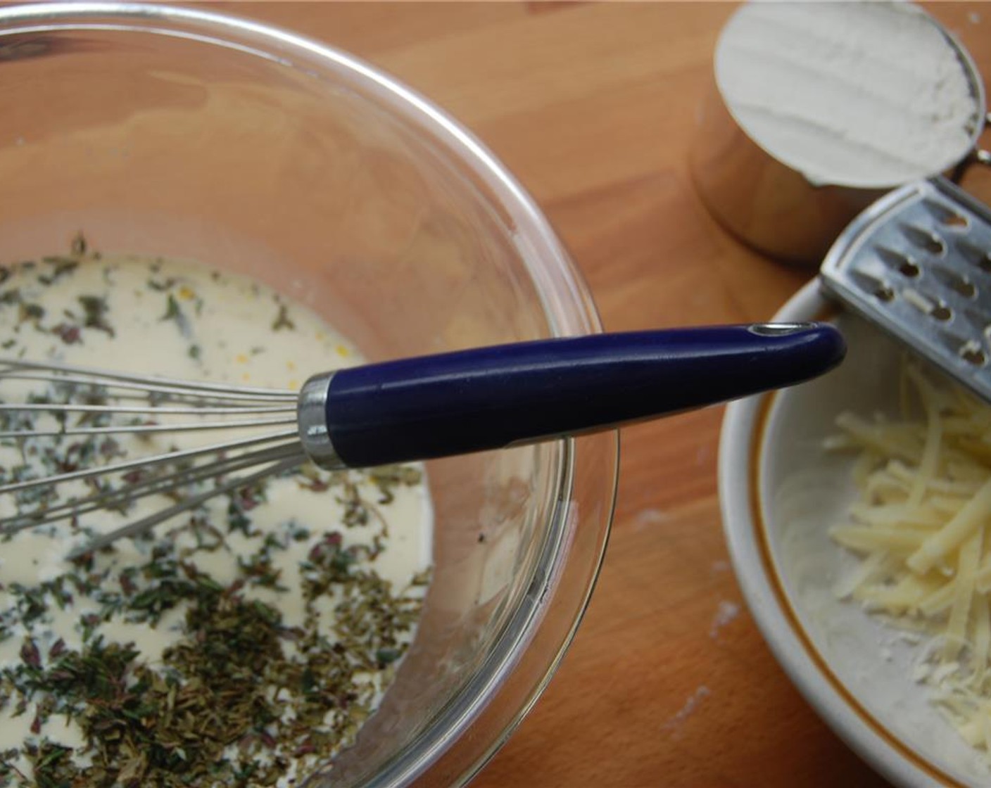 step 2 Stir in Cheddar Cheese (1/3 cup), Dried Oregano (1/2 tsp) and Dried Thyme (1 1/2 Tbsp). Let the batter rest for an hour.