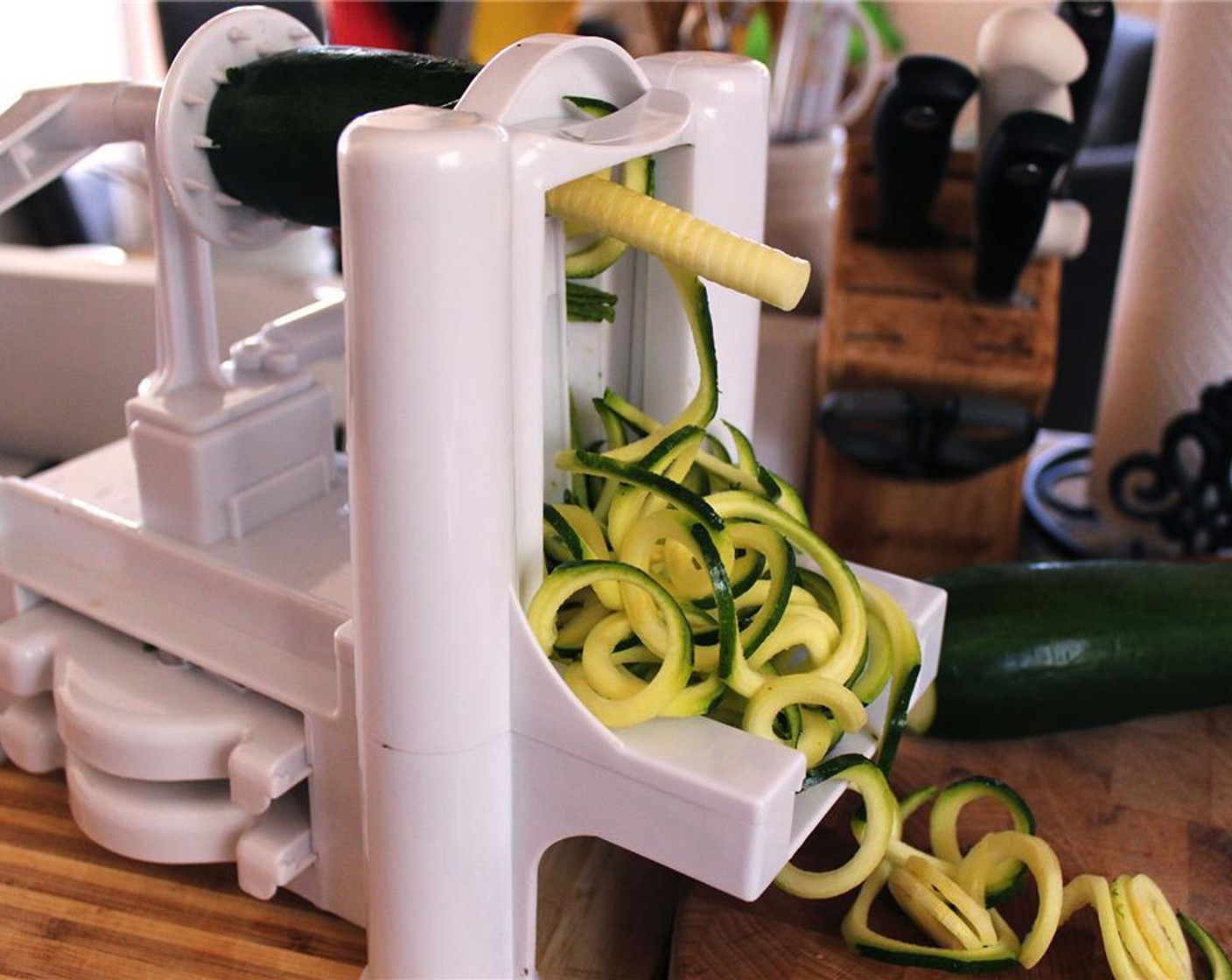 step 4 While the tomatoes are roasting, prepare the Zucchini (4) using either a spiralizer, vegetable peeler, or julienne peeler. Set aside in a large bowl.