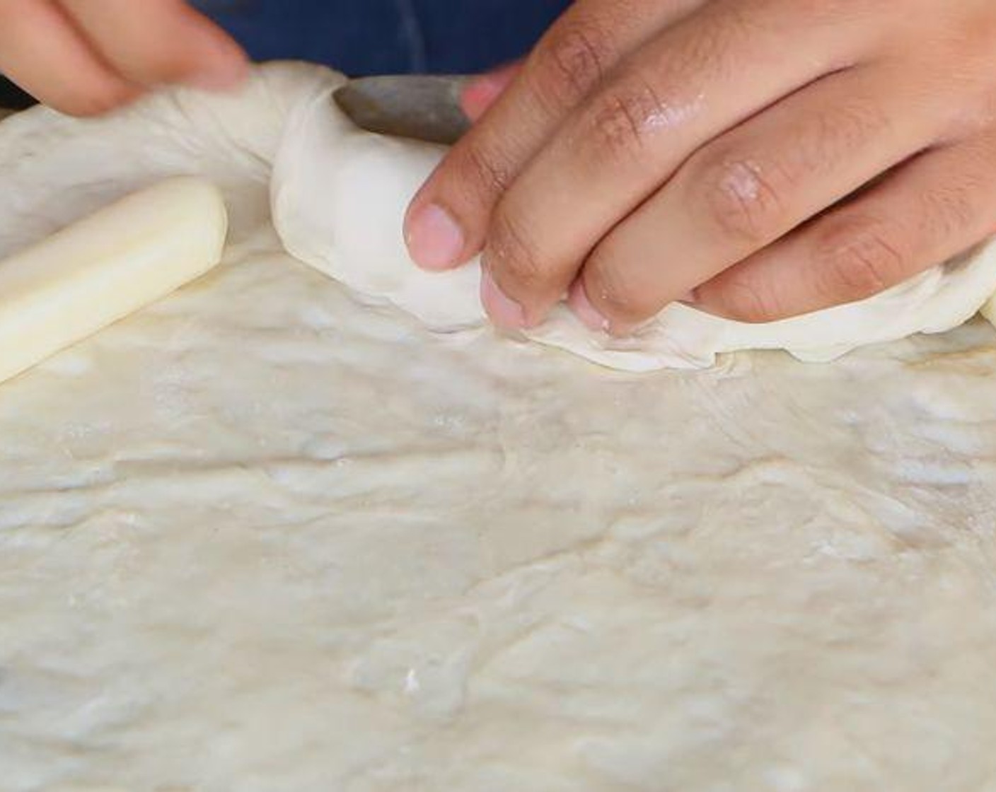 step 3 Place the Mozzarella String Cheese (7) around the border of the pizza dough. Wrap the dough over the cheese to form the cheesy crust.