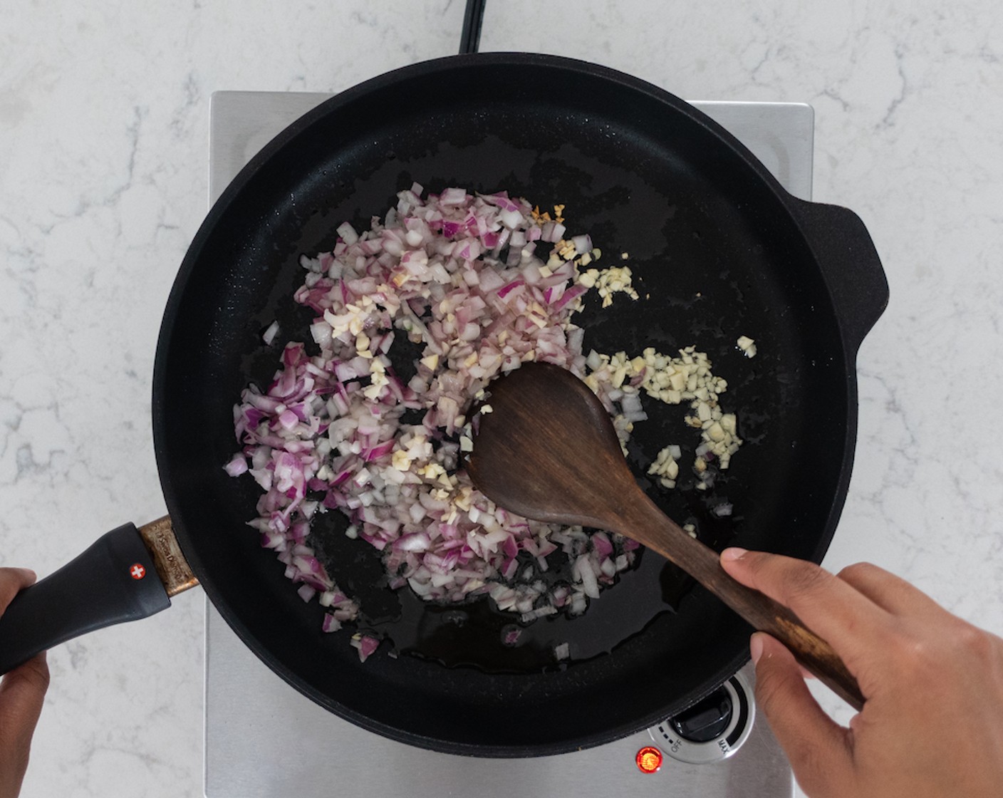 step 3 While rice is cooking, heat Avocado Oil (2 Tbsp) over medium-high heat in a large skillet. Add garlic and red onions; sauté, stirring occasionally, for 3 minutes.