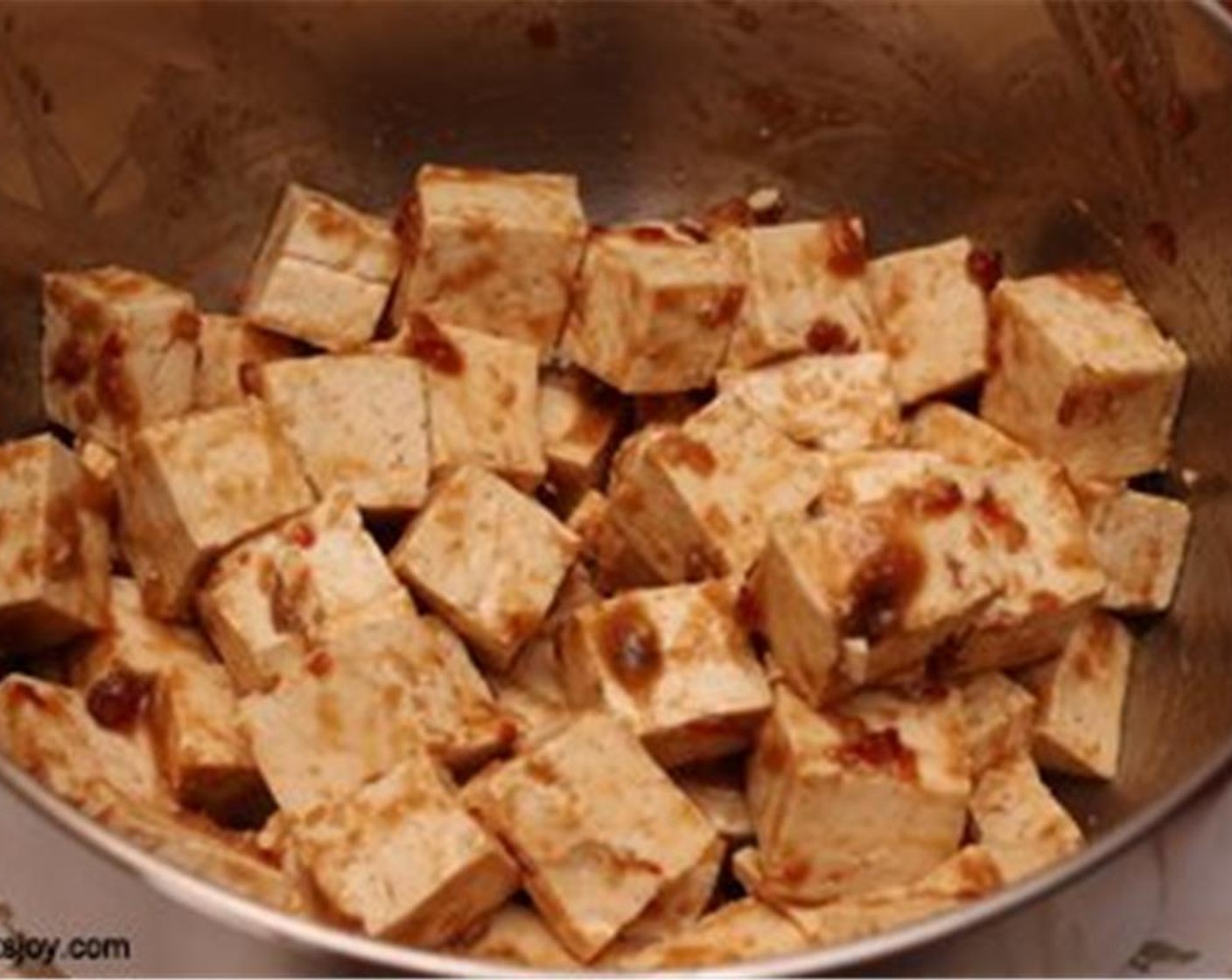 step 3 Add the cubed tofu to it and toss to combine. Let it sit for about 30 minutes to an hour. Preheat your oven to 350 degrees F (180 degrees C).