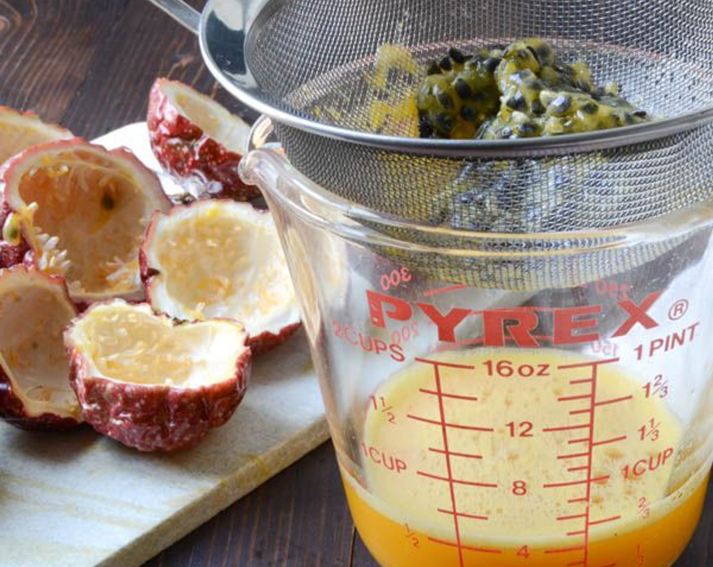 step 13 Rest a fine mesh sieve over a small bowl and pour the passion fruit into the sieve. Use the back of a spoon to press out the juice, stirring and pressing several times, until you're just left with pulp and seeds in the sieve.