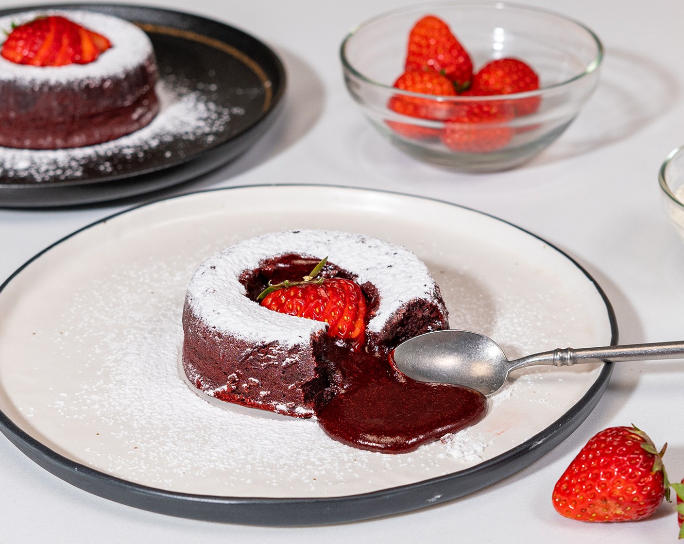 step 13 Allow the cakes to cool for 5 minutes before unmolding. Serve warm with a dusting of powdered sugar and garnish with Fresh Strawberries (to taste). Enjoy with the cocktails!