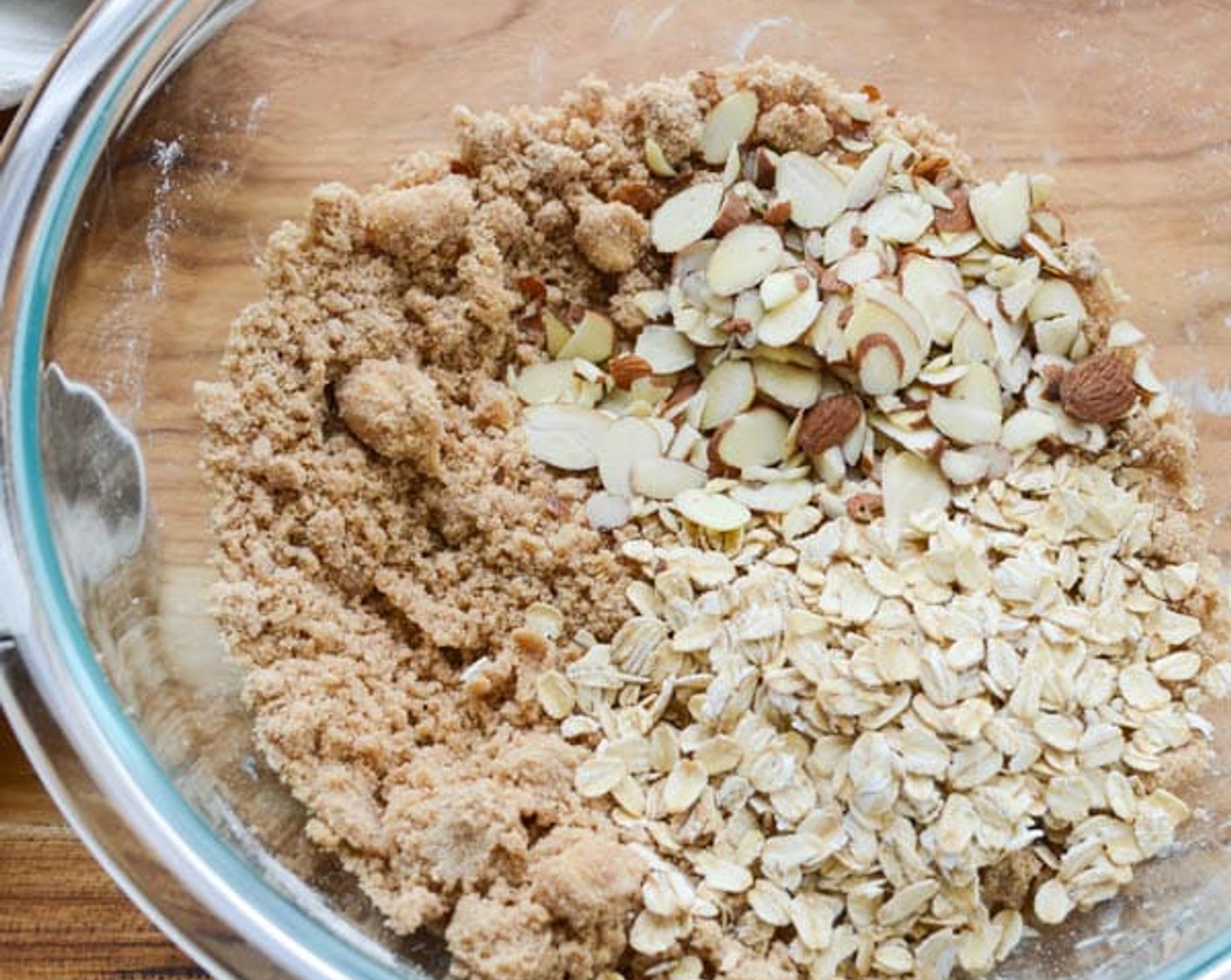 step 3 In a medium bowl combine the Brown Sugar (1/2 cup), All-Purpose Flour (1/2 cup), Salt (1/4 tsp), and Simply Organic Cinnamon, Ground (1/4 tsp). Add Unsalted Butter (4 Tbsp). With your fingers, rub the butter into the flour mixture, working until it resembles wet sand.  Add Oatmeal (1/2 cup) and Sliced Almonds (4 Tbsp). Toss to combine.