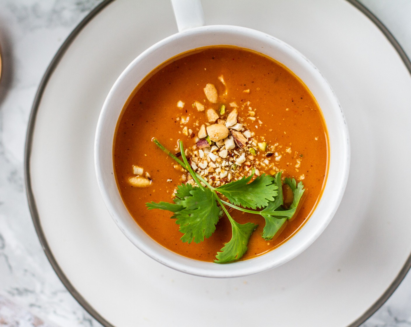 step 9 To serve add 4 ounces of soup to a bowl, garnish with 1 tablespoon of chopped peanuts, and Fresh Cilantro (12 sprigs) sprig.