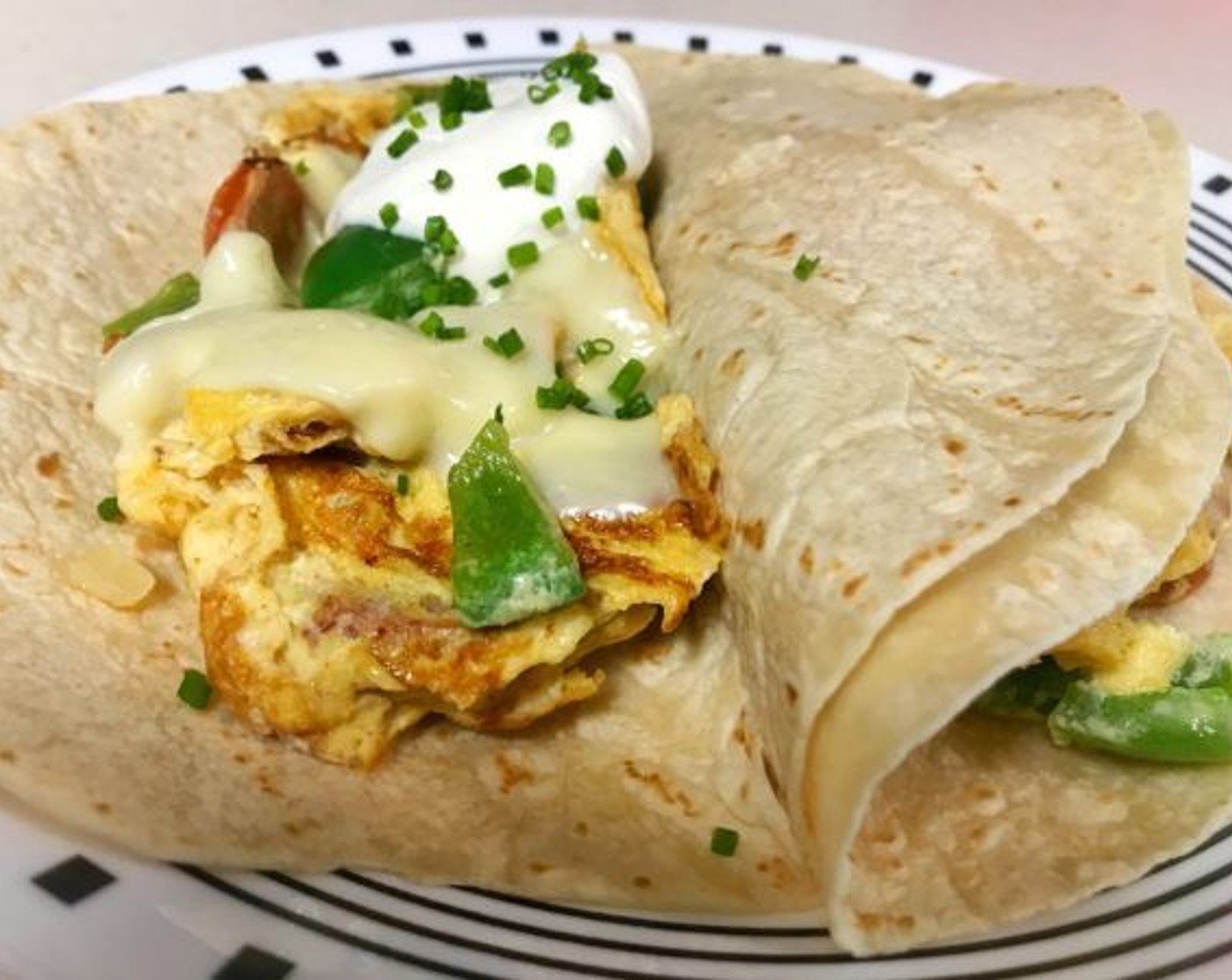 step 7 Divide eggs and place on tortillas. Top each tortilla with a tablespoon of Sour Cream (3 Tbsp) and chopped Fresh Chives (1 Tbsp).
