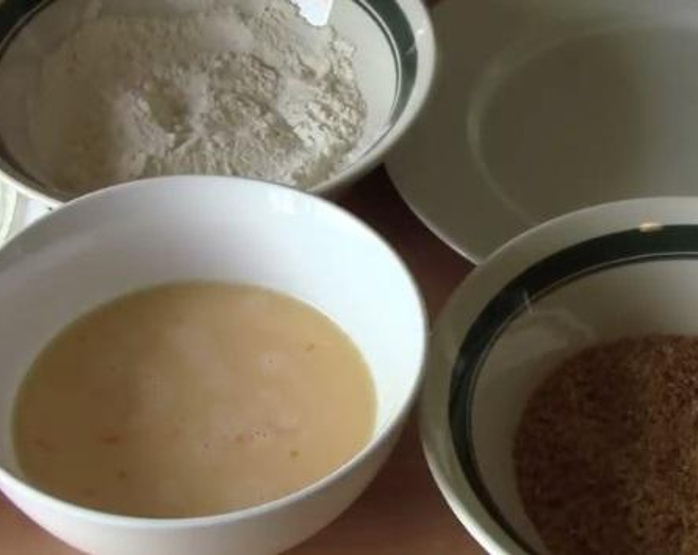 step 1 In a bowl mix together the All-Purpose Flour (1 cup), Salt (to taste), Ground Black Pepper (to taste), and McCormick® Garlic Powder (1 tsp). In another bowl mix together the Eggs (2) and Milk (1/4 cup). In a third and separate bowl, crush the Corn Flakes (2 cups) into small pieces.