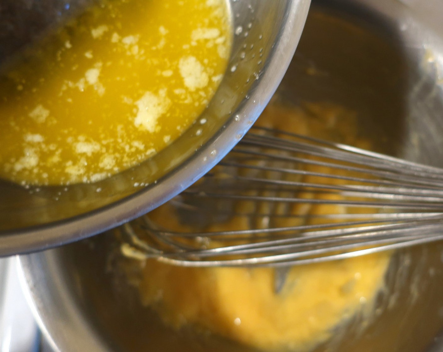 step 8 Add the warm butter in tiny increments. If the sauce becomes too thick, add more water; if the sauce is too thin, add more butter.