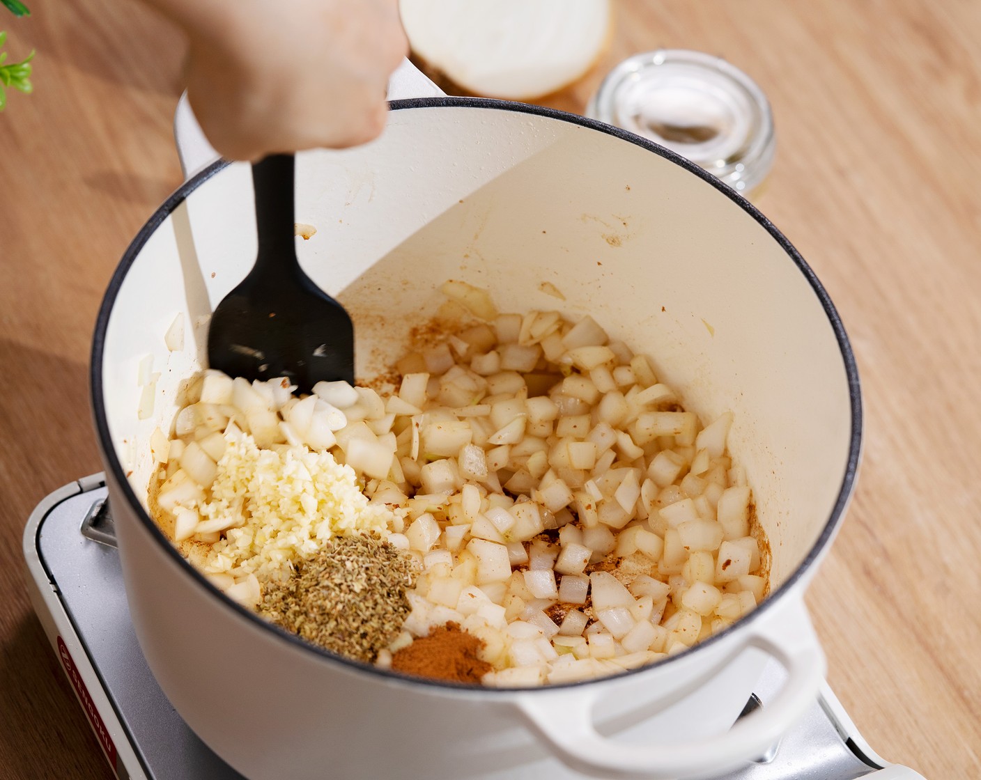 step 6 To the same pot, add White Onion (1) and cook until soft. Add Garlic (5 cloves), Dried Oregano (1 Tbsp), and Ground Cinnamon (1/2 tsp) and cook for another minute.