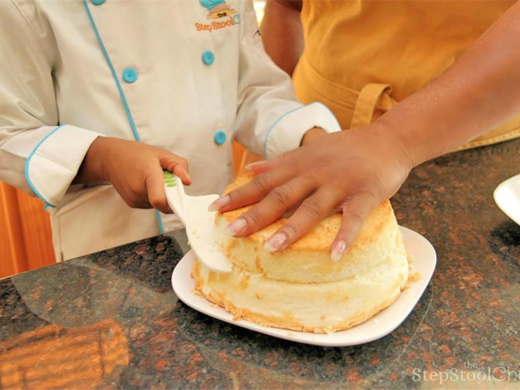 Step 3 of YaYa's No-Bake Strawberry Shortcake Recipe: Next, slice the Angel Food Cake (1) across the middle allowing you to remove the top half of the cake and place on a separate plate.