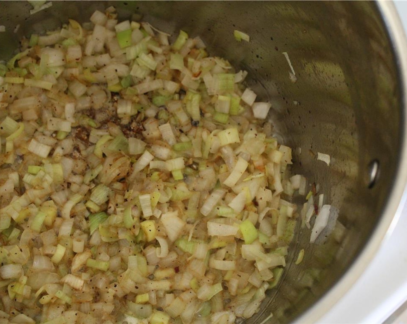 step 6 Add in Butter (3 Tbsp), leek, onion, and some Salt (to taste). Sauté until onion and leek are translucent, not brown. About 10 minutes.