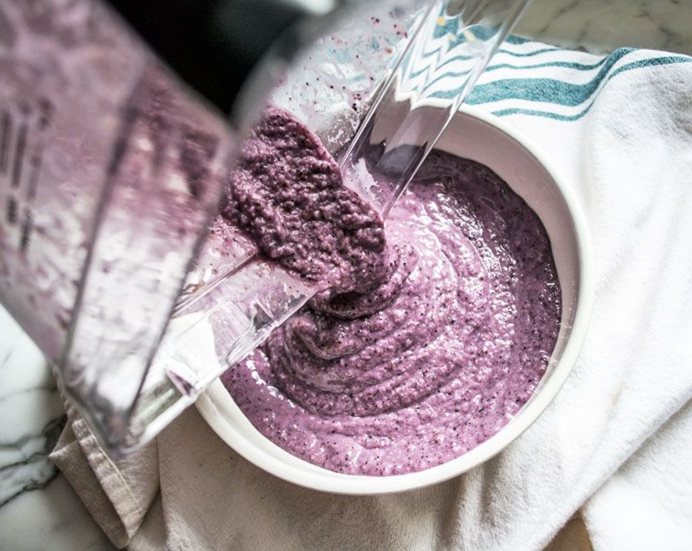 step 1 Add Banana (1), Frozen Blueberries (1/2 cup), Unsweetened Vanilla Almond Milk (1/2 cup), Pitted Dates (1/4 cup), Creamy Peanut Butter (1 Tbsp), and Ice (to taste) to a high power blender. Blend until smooth.