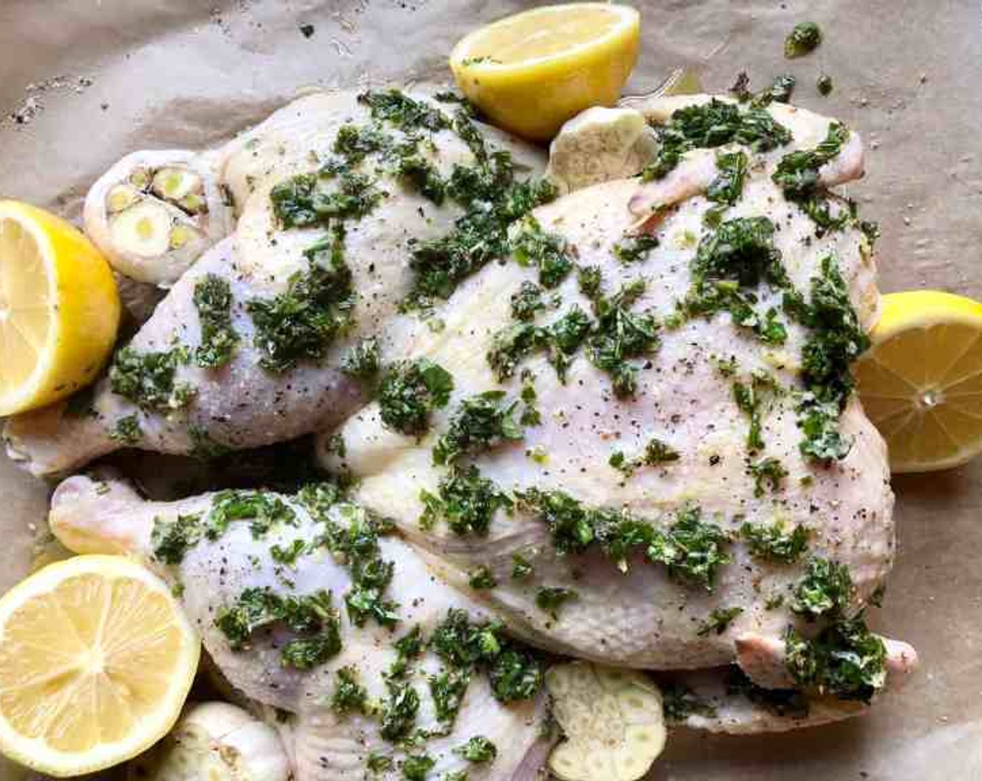 step 5 You can optionally add a few lemon halves and cut heads of garlic to the pan before baking. Bake skin-side up for 50 minutes with a rotation of the pan halfway through to ensure that it cooks evenly.