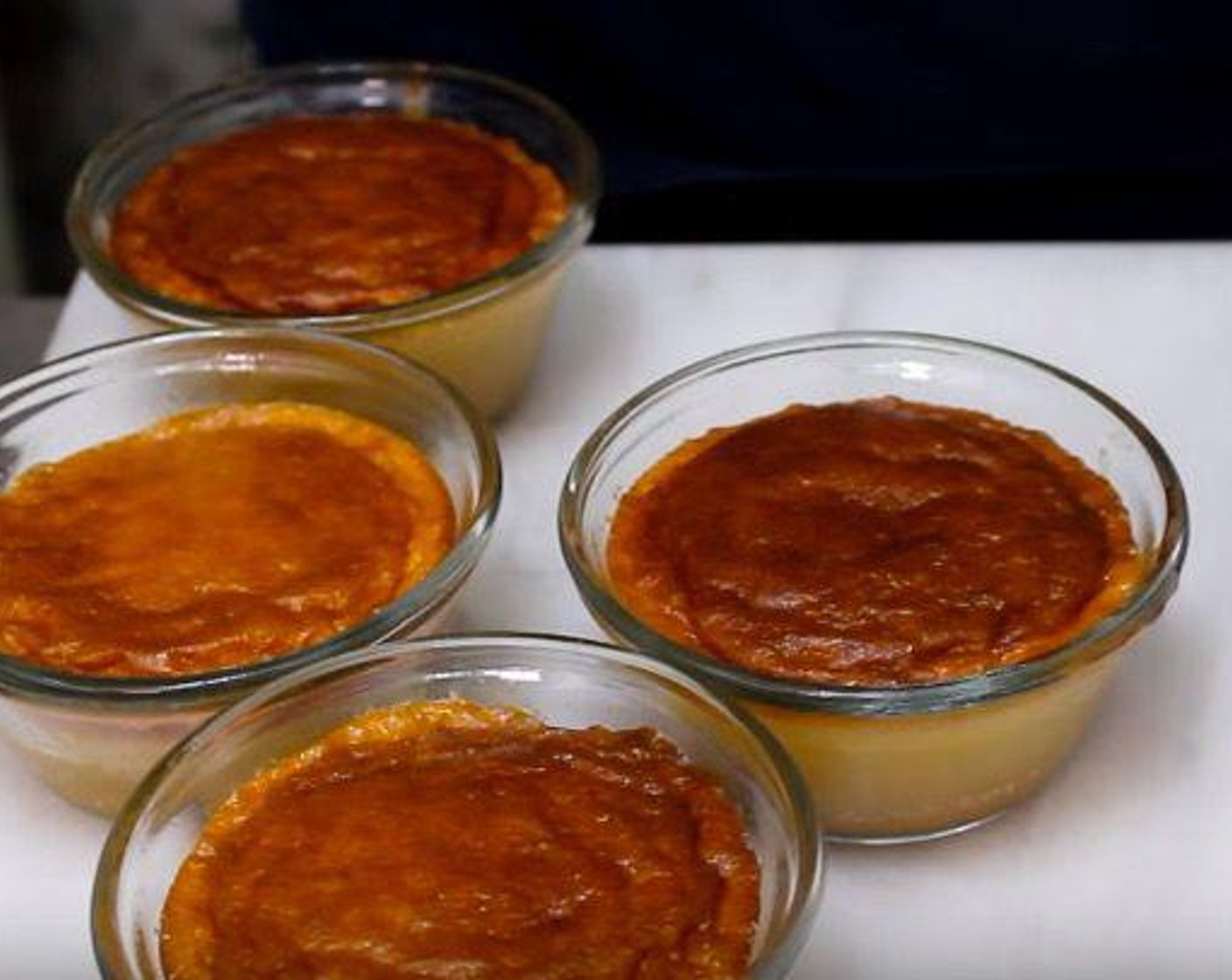 step 6 Divide batter among ramekins. Place ramekins on a baking sheet. Bake cakes until outsides are golden brown in color but the centers still jiggle, 9-10 minutes.