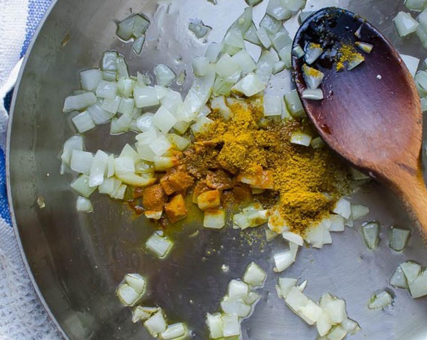 step 3 In a large skillet, heat Olive Oil (1 1/2 Tbsp) over medium heat. Add the Onion (1) and cook for two minutes. Stir in the Ground Turmeric (1/4 tsp), Curry Powder (1/2 tsp) and Kosher Salt (1/2 tsp).
