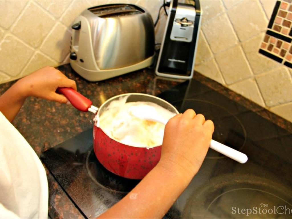 Step 11 of Simple Vanilla Soufflé Recipe: Fold the foamy egg white mixture with the vanilla batter.