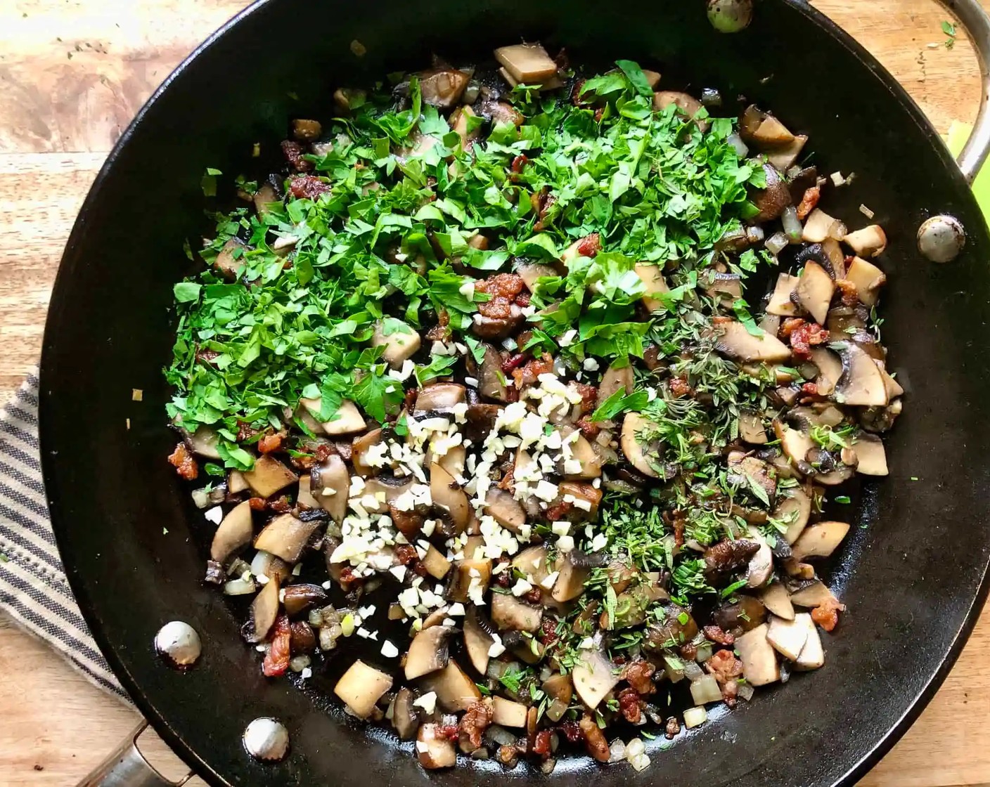 step 7 Add the Garlic (1 clove) along with the Fresh Parsley (1/4 cup), Fresh Rosemary (1 Tbsp), and Fresh Thyme (1 Tbsp). Season with Salt (1/2 tsp) and Freshly Ground Black Pepper (1/4 tsp). Cook for one more minute, stirring constantly. Transfer to a plate.