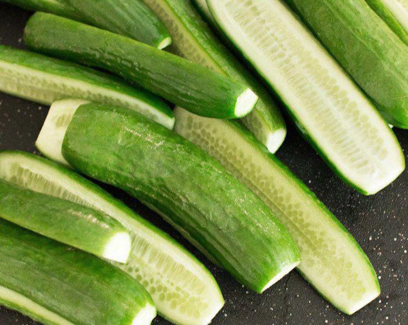 step 1 Cut off the ends of the Persian Cucumbers (9 2/3 cups) and slice them in half long-ways.