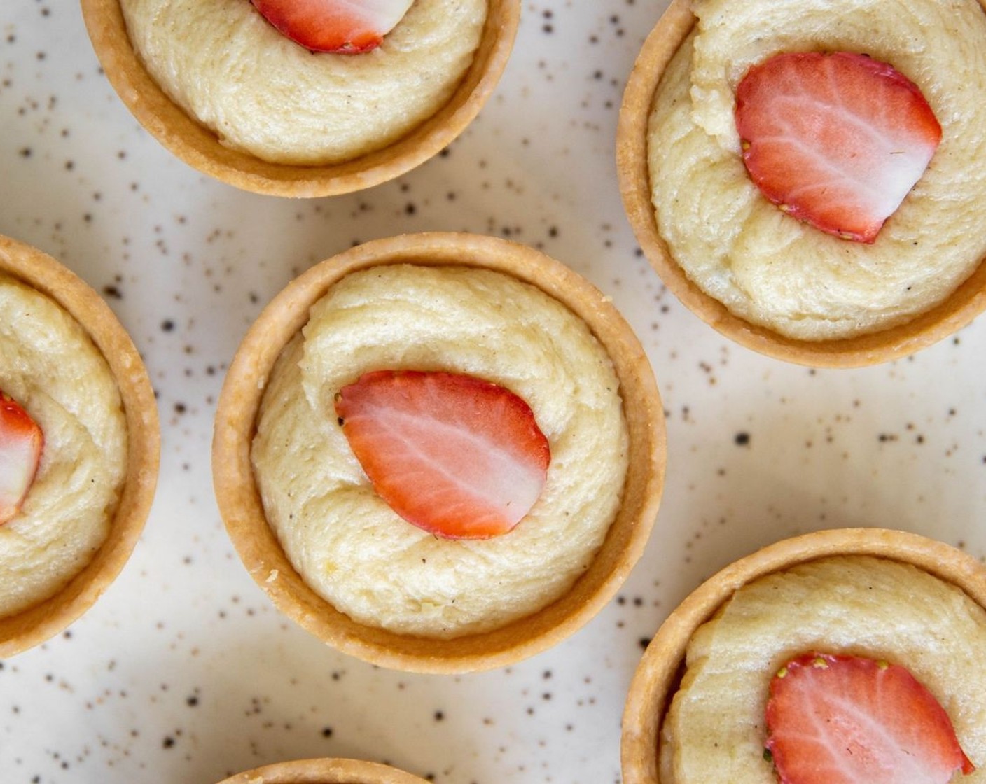 step 6 Press your Fresh Strawberries (to taste) into the tart and bake for 20-25 minutes or until the tarts are golden brown on top. If you make one large tart it will take between 45-50 minutes.