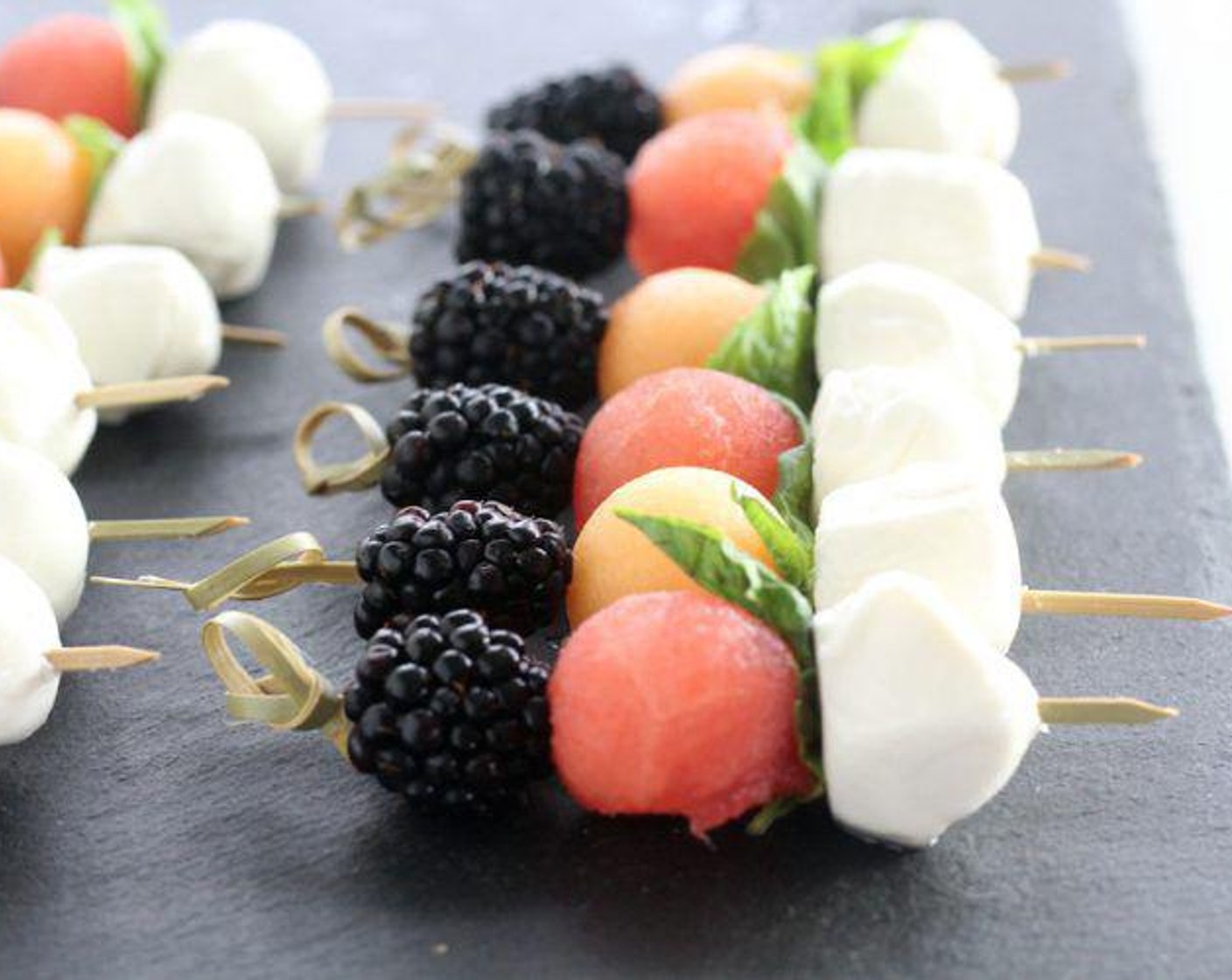 step 2 Assemble each pick with 1 Fresh Blackberry (1 cup), 1 melon ball, 1 Fresh Basil Leaf (1/2 cup), and 1 Fresh Mozzarella Cheese Ball (1 1/2 cups). Serve and enjoy!