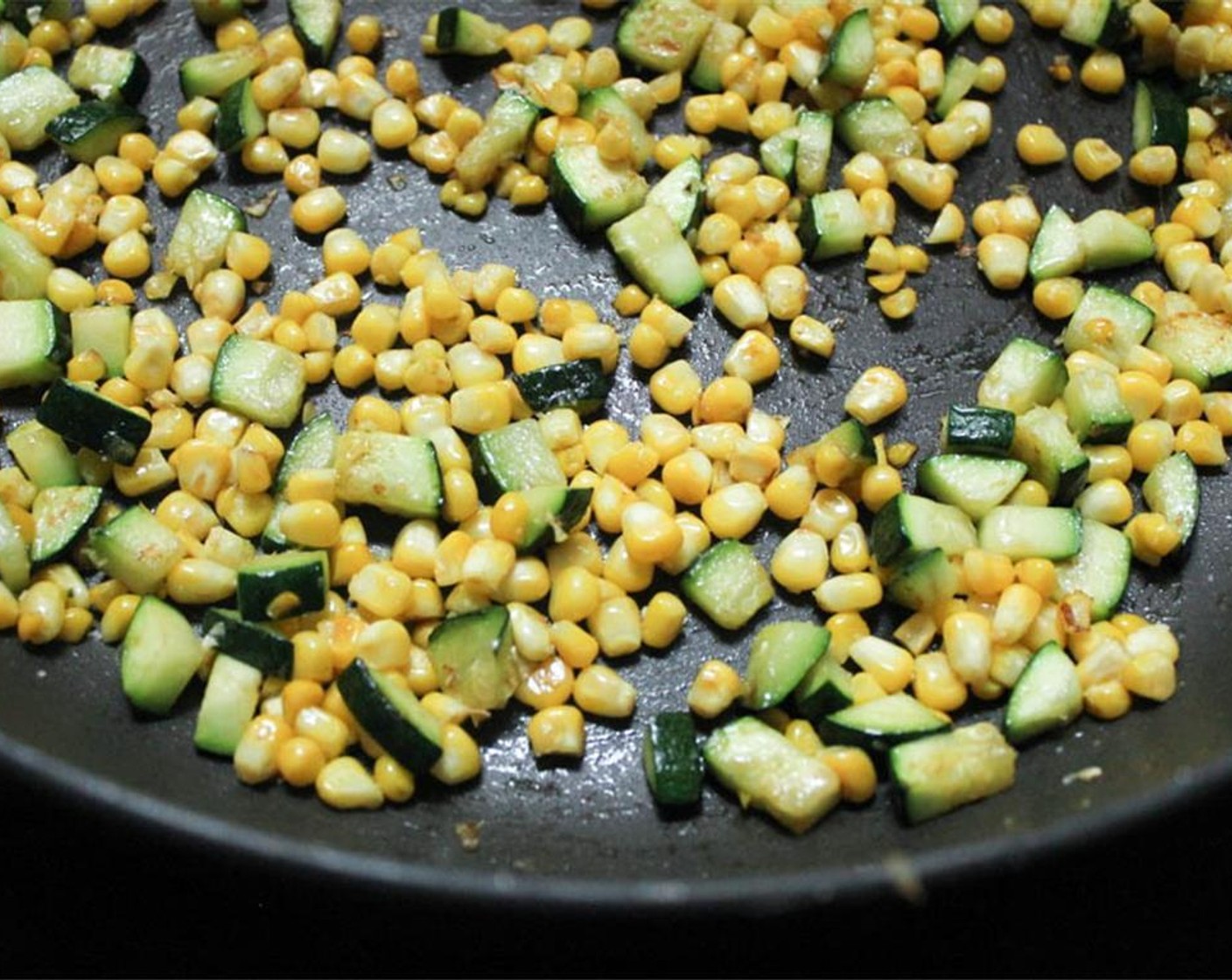 step 2 Heat a tablespoon of Olive Oil (1 Tbsp) in a large skillet. When hot, add the Corn (1 ear), Zucchini (1) and Salt (to taste). Sauté for 8 minutes until tender and lightly browned.