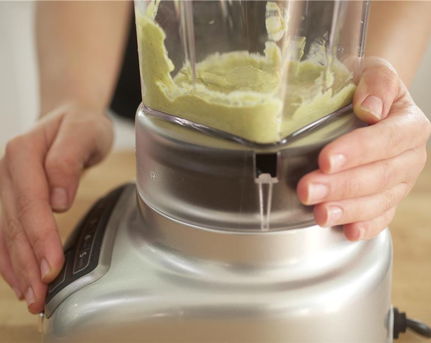 step 8 Add Sour Cream (4 Tbsp), Ground Cumin (1/4 tsp), Chili Powder (1/4 tsp), Salt (1/4 tsp), and Ground Black Pepper (1/4 tsp) to the avocado, garlic, and lime juice in the blender. Blend until smooth.