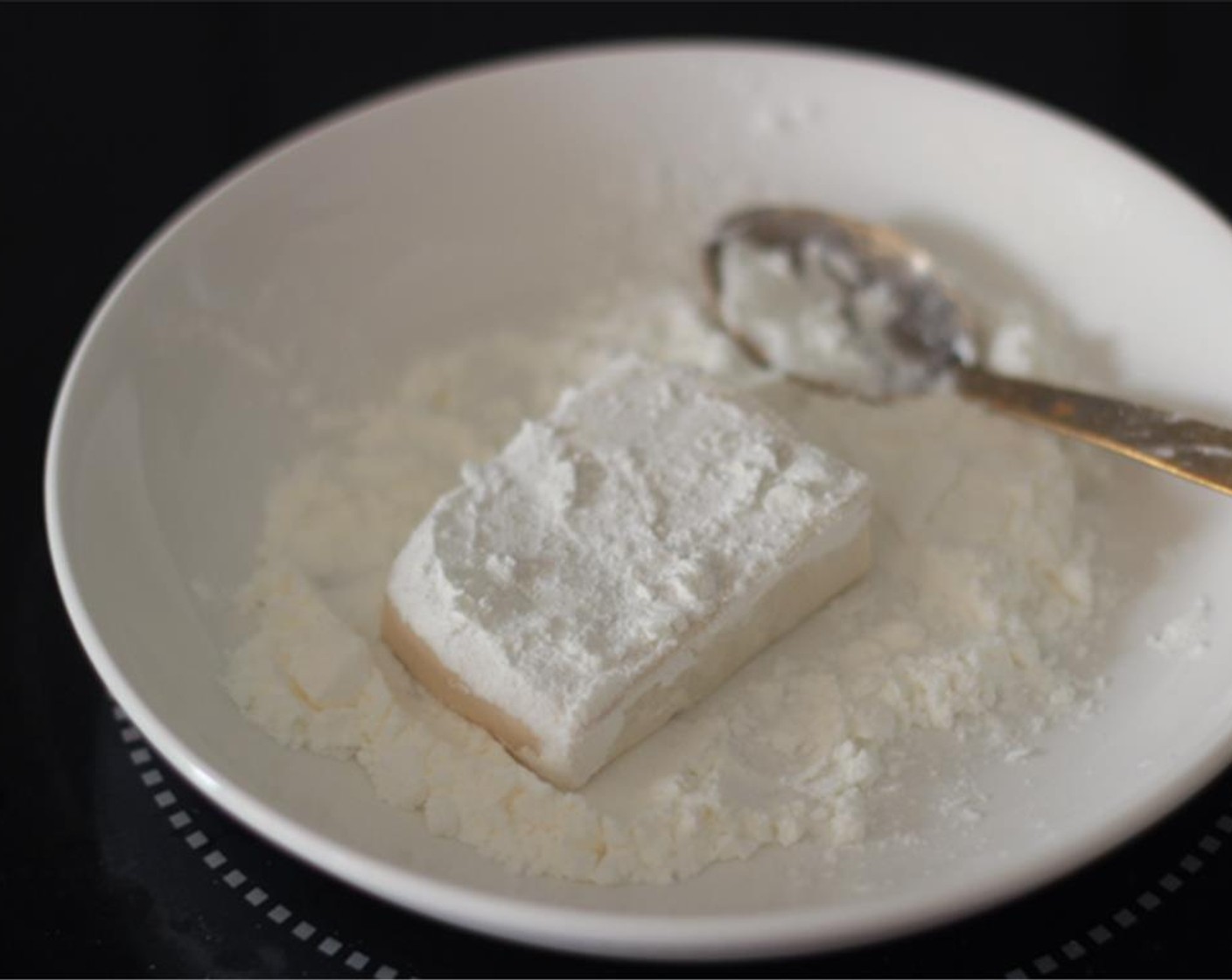 step 2 Cut the Tofu (1 pckg) into 1cm thick, 4 cm wide slices. Coat the tofu in Corn Starch (to taste).