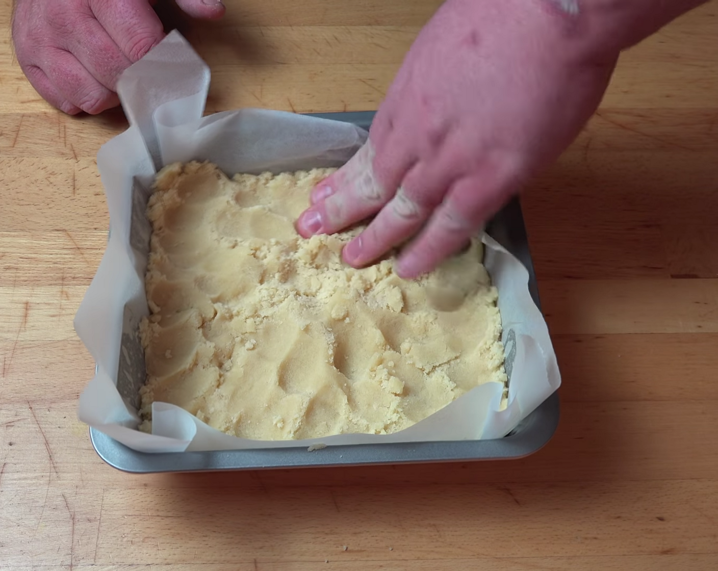 step 6 Transfer 3/4 of the dough mixture into the cake pan. Using your fingers press all the way to the edges, to make it smooth and even on the top. You can also use a flat bottom glass to make the top even.