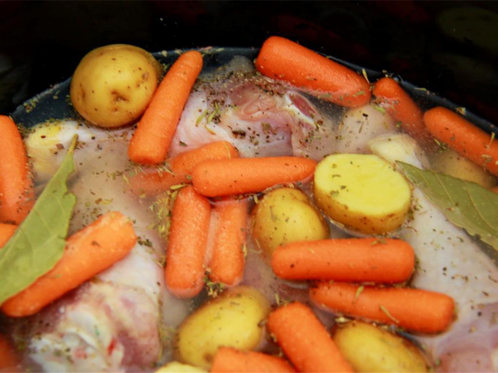 Step 3 of Rainy Day Stewed Chicken & Veggies Recipe: Add the chopped onion and potatoes, along with the French Baby Carrots (2 cup) to the slow cooker.
