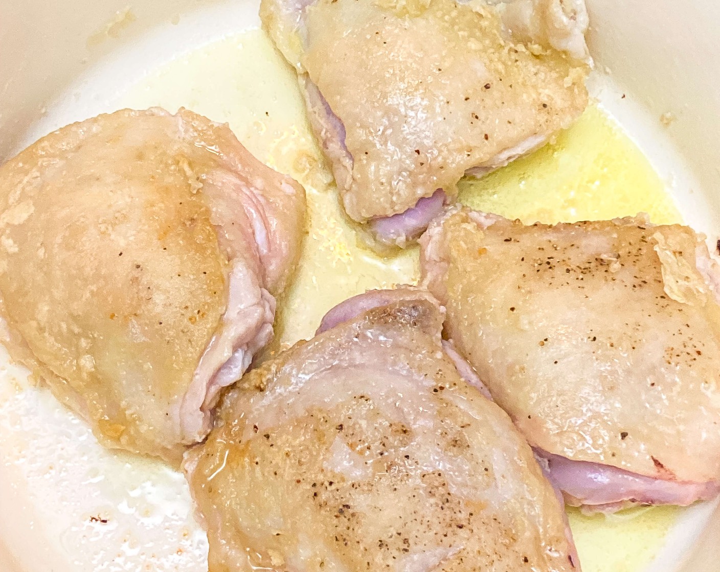 step 2 Heat Olive Oil (2 Tbsp) in a large Dutch oven or pot over high heat, or set Instant Pot to sauté on high. Once the oil is hot, add chicken thighs and brown on both sides, about 2 minutes. Remove chicken thighs from the pot and place them on a plate for later.