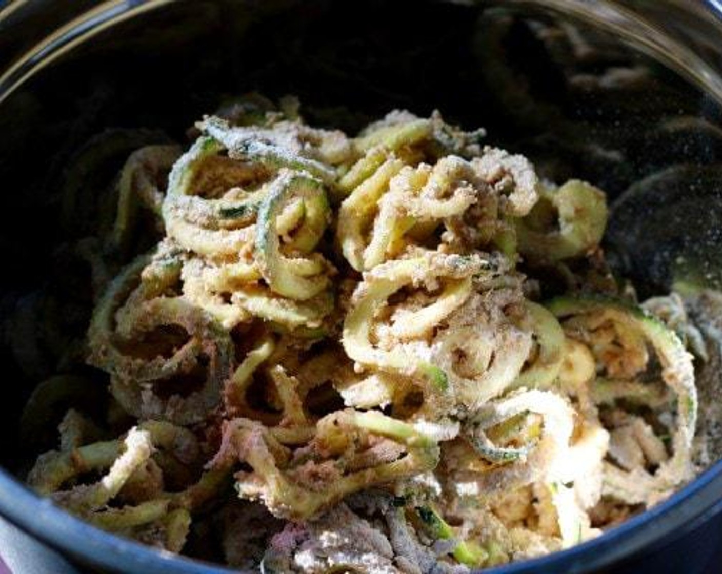 step 2 Dip the spiralized zucchini into the Eggs (4) with Salt (to taste) and Ground Black Pepper (to taste) and then into the All-Purpose Flour (2 cups). Place into and additional bowl as you continue the process.