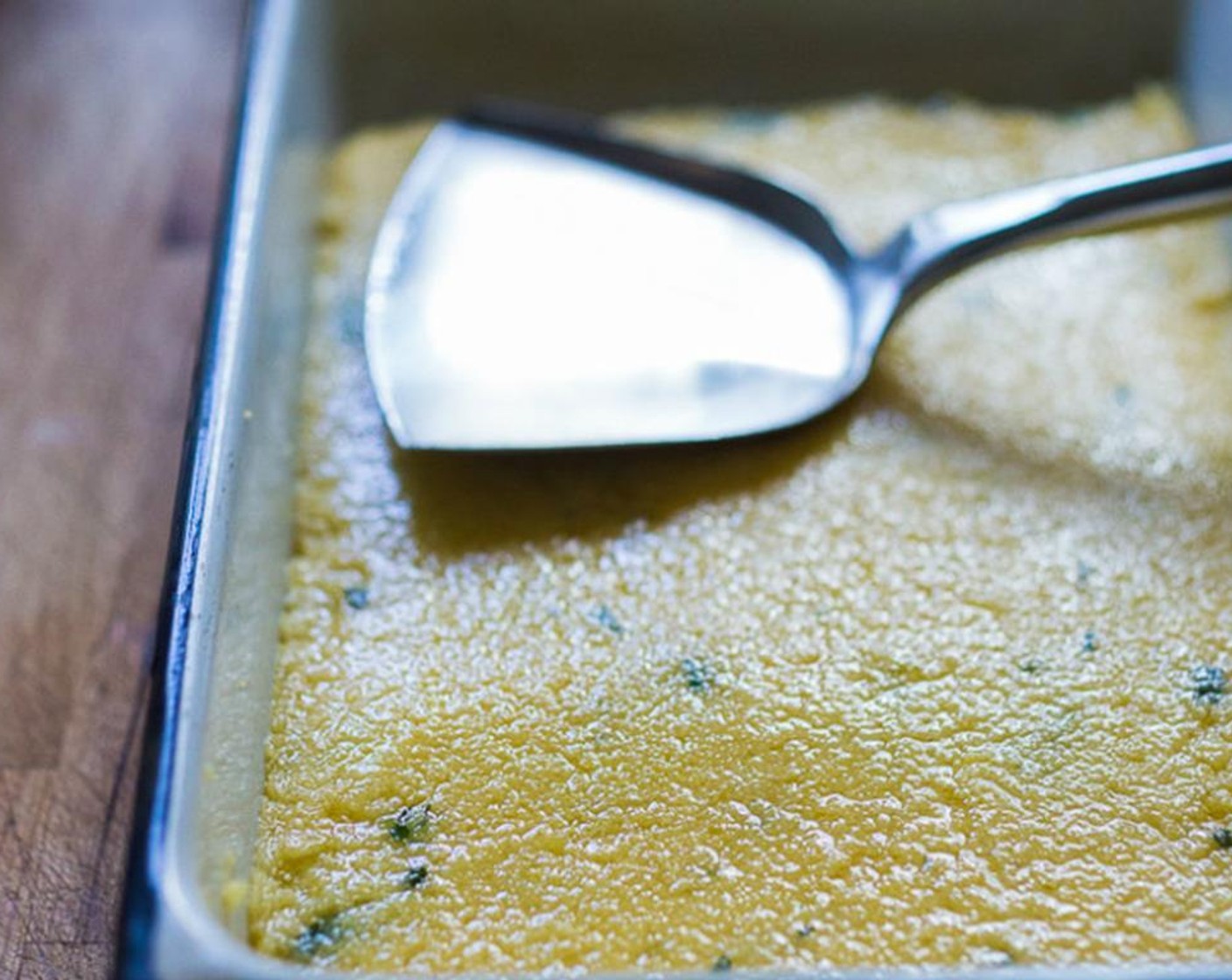 step 9 Spread on a greased baking dish, smoothing out with a flat bottom metal spatula, coated in olive oil, to 3/4-inch thickness. Refrigerate, until firm and chilled over night or for at least 2 hours.