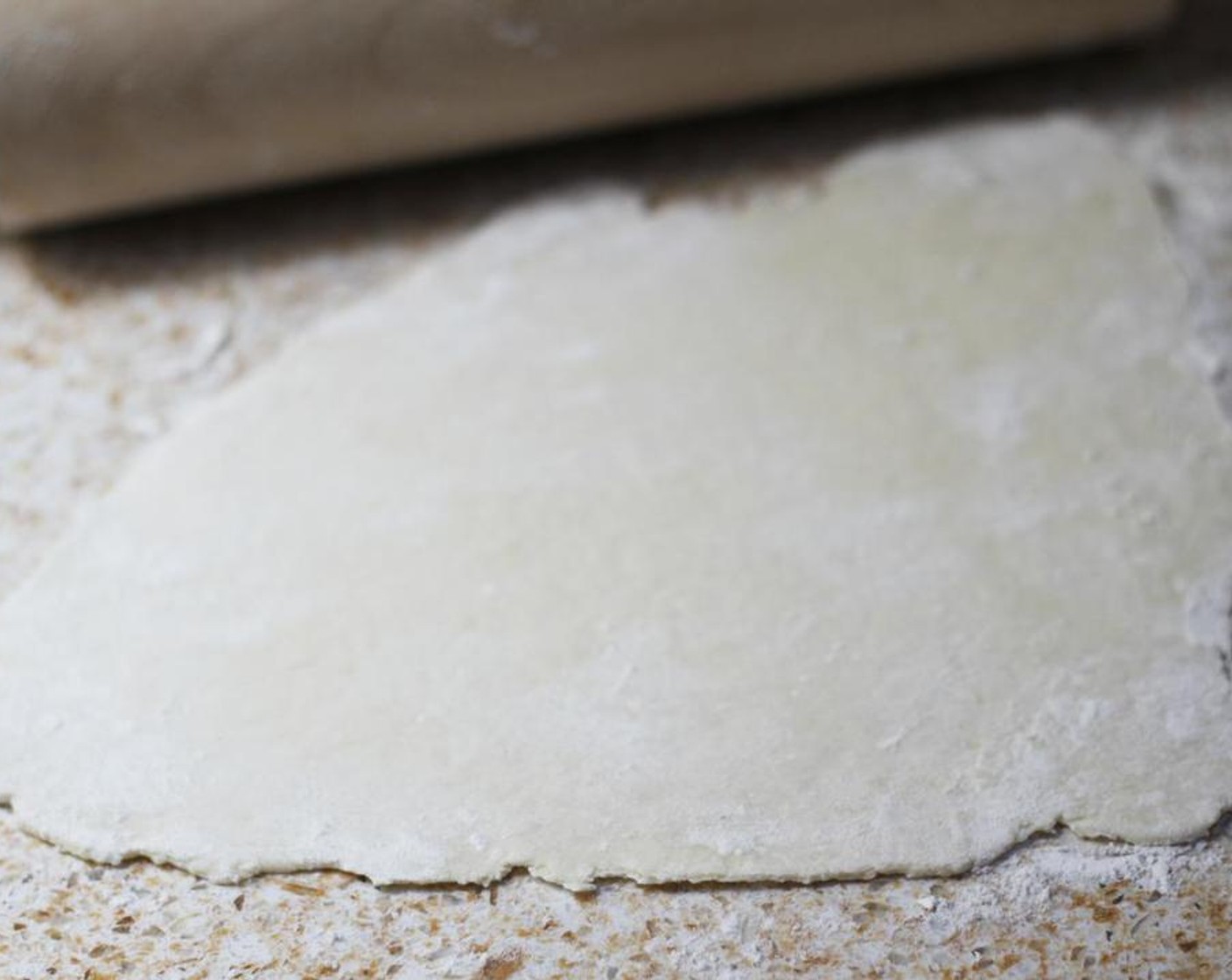 step 6 Working quickly, roll out each piece of dough as thinly as you can with a rolling pin.