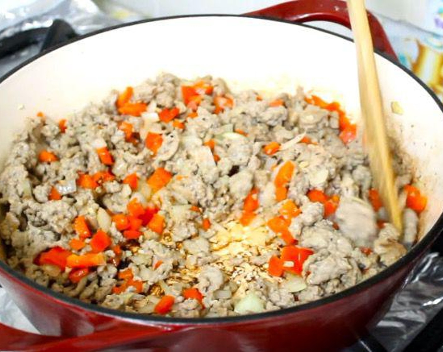 step 2 Add Red Bell Peppers (2), Garlic (3 cloves), and Onion (1). Cook until vegetables start to soften.