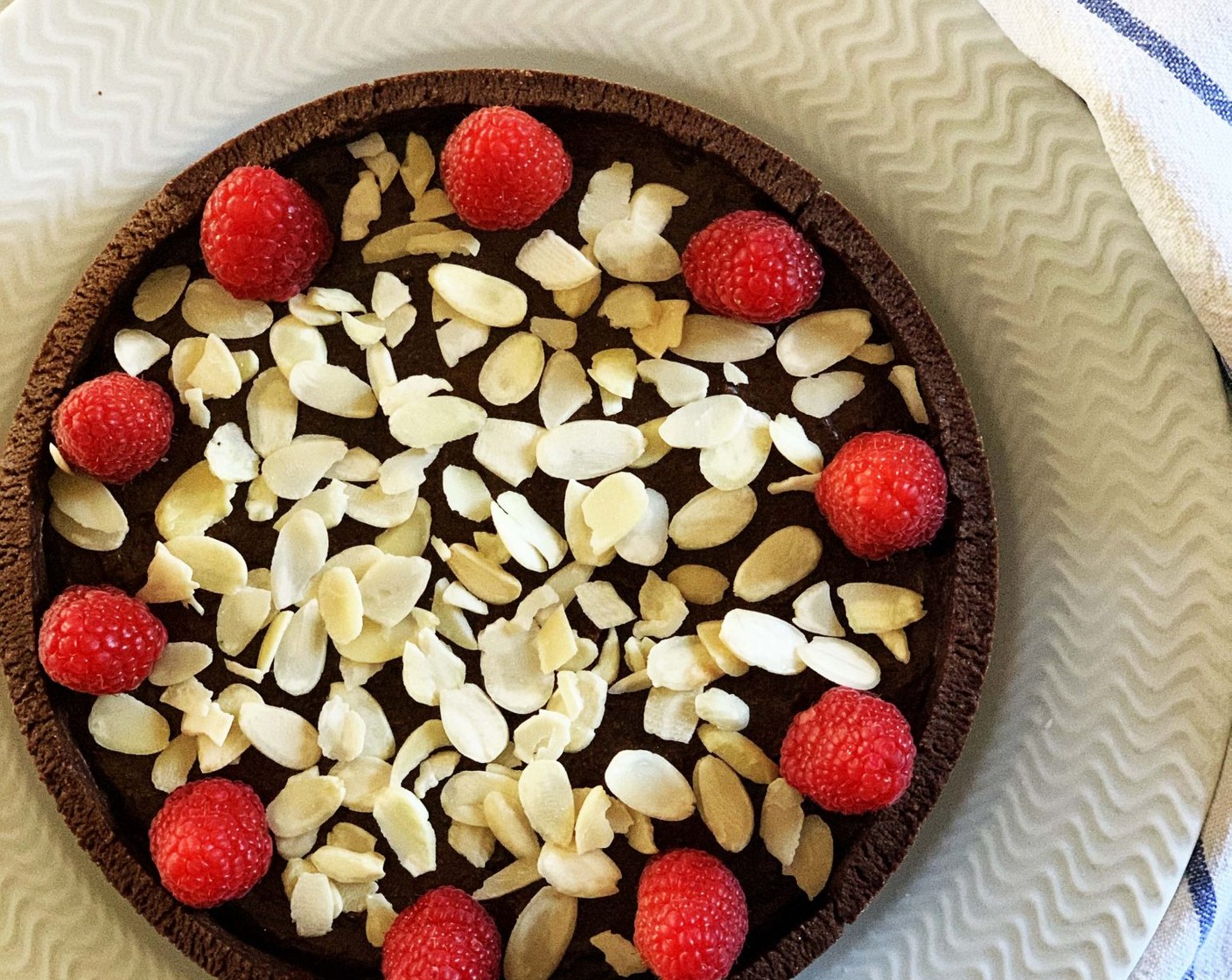 step 10 Remove from the oven and let the pie cool down completely. Decorate then with Fresh Raspberries (to taste) and Sliced Almonds (to taste).