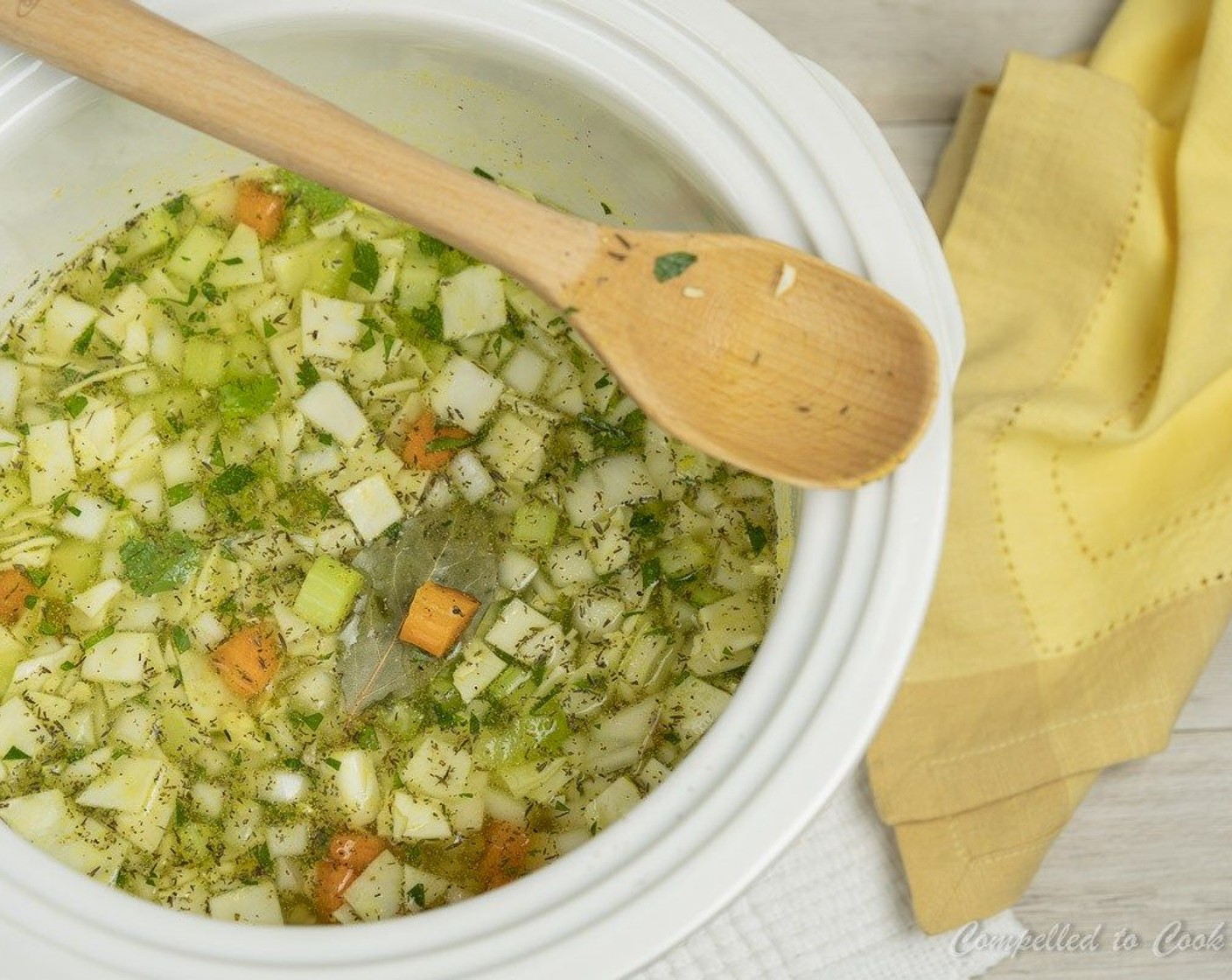 step 2 Add lentils along with White Onions (1 1/2 cups), Celery (2 stalks), Carrots (2), Green Cabbage (2 cups), Garlic (2 cloves), Fresh Parsley (1 Tbsp), Bay Leaf (1), and Dried Thyme (1/2 tsp) to your slow cooker.