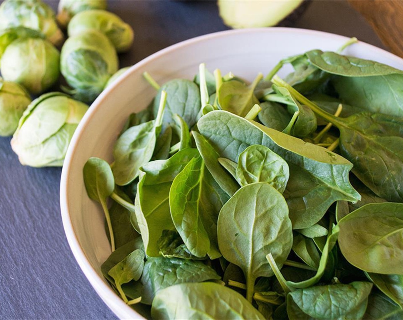 step 8 While veggies cook, fill two bowls with Fresh Spinach (4 cups), Eggs (2), Canned Chickpeas (1/4 cup), Pecans (1/4 cup), Feta Cheese (3 Tbsp), and Avocado (1).