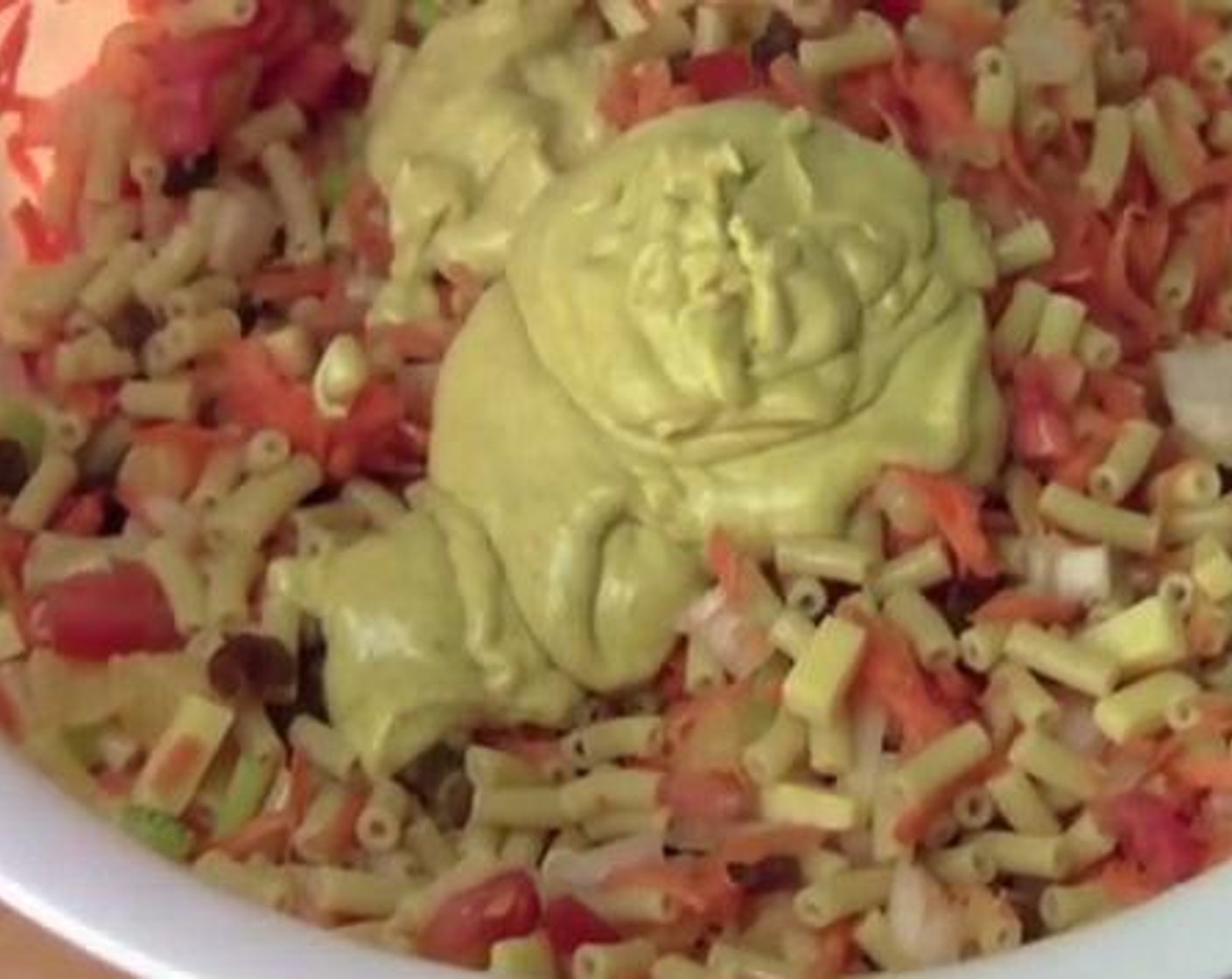 step 3 Into the pasta, add and toss together the Carrots (2), Tomatoes (2), White Onion (1), Celery (2 stalks), Sun-Maid Raisins (1/2 cup), and Cheddar Cheese (3/4 cup).