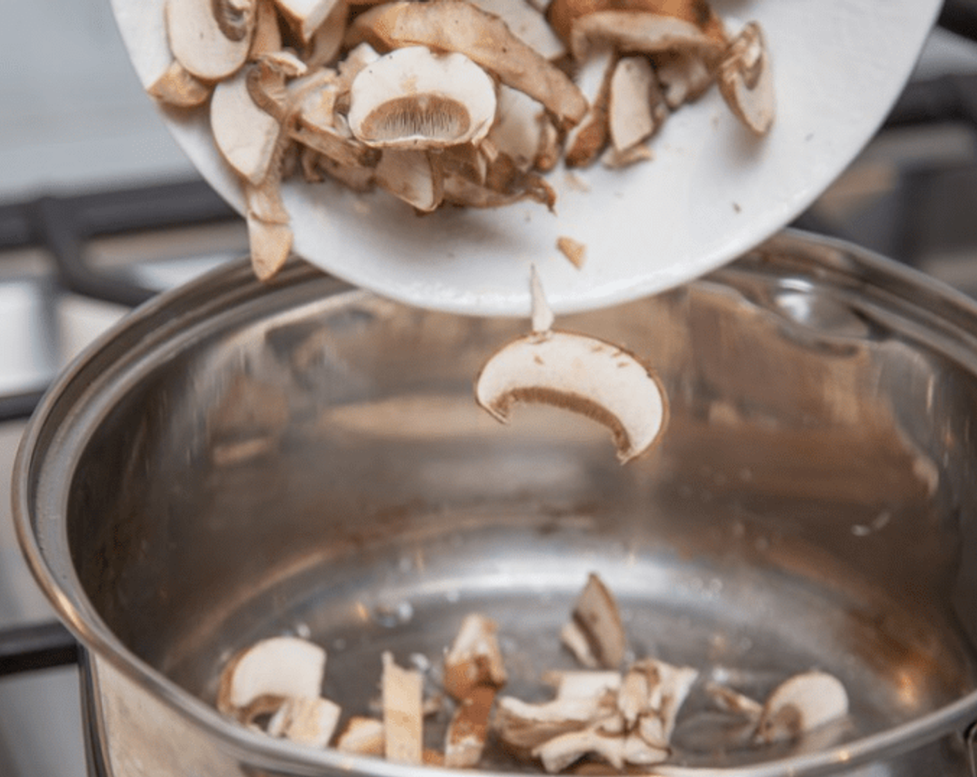 step 3 Heat a saucepot over medium heat. Add Cooking Oil (1 Tbsp), then mushrooms. Cook without stirring 3-4 minutes. Stir in garlic and green onion whites.