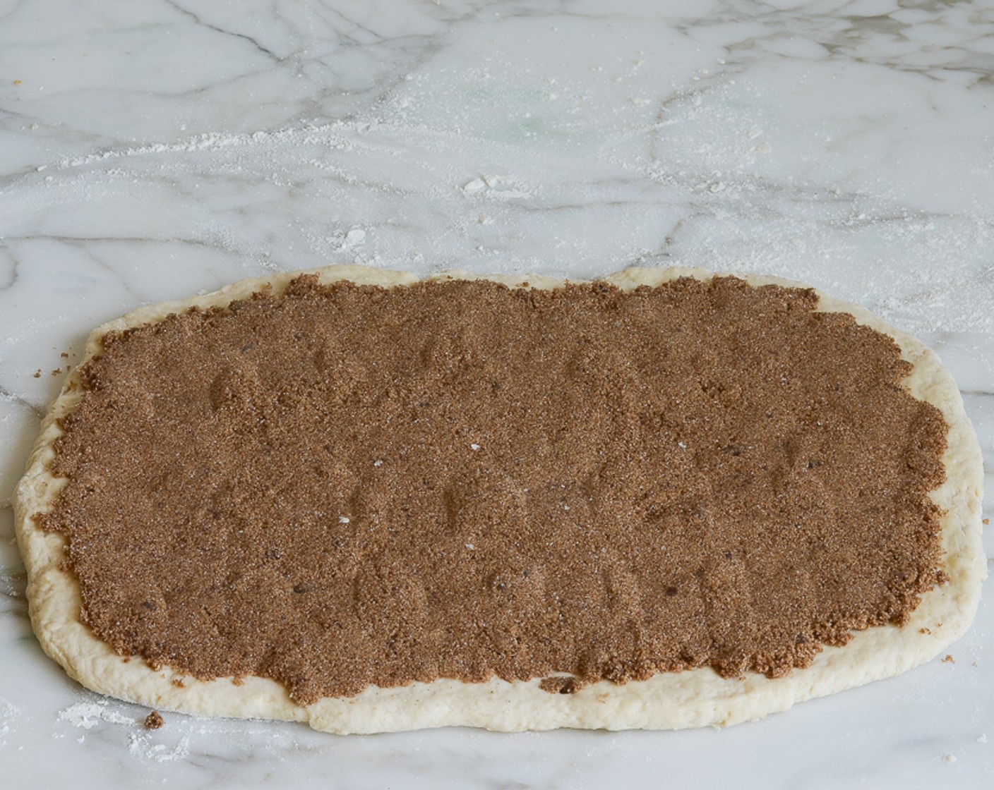 step 8 Brush the dough with 1 tablespoon of Unsalted Butter (1 Tbsp). Sprinkle the dough evenly with the brown sugar filling, leaving a 1/2-inch border. Using your hand, press the filling firmly into the dough.