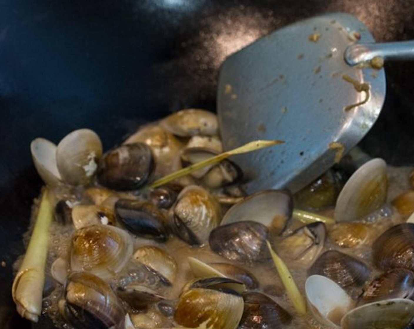 step 7 As soon as the clams start to open up, add the Water mixed with Corn Starch (1 tsp). This will thicken up the sauce. By now, most if not all of the clams should be opened.