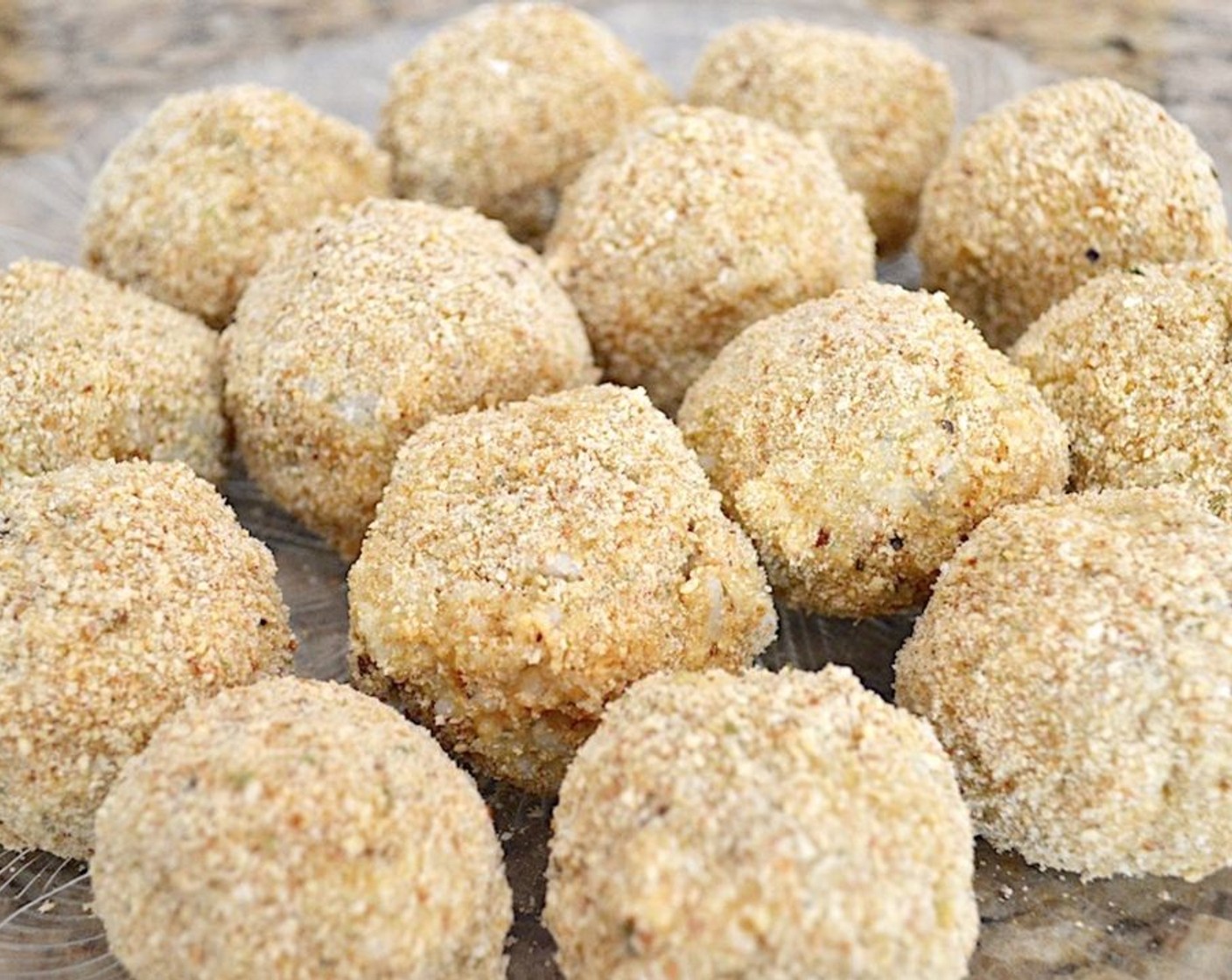 step 5 Make little balls of the rice mixture the size of your palm and put each one through the breading procedure with the flour first, then the eggs, then the breadcrumbs. When you've breaded all of your arancini, set the platter in the fridge for an hour to set.