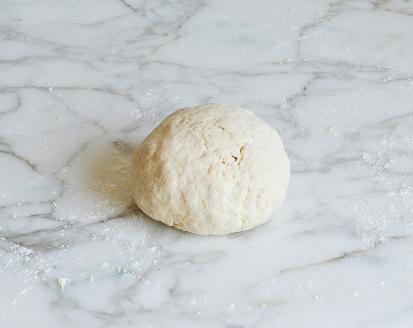 step 6 Transfer the dough to a lightly floured work surface. Knead, lightly until just smooth and no longer shaggy, about 30 seconds.