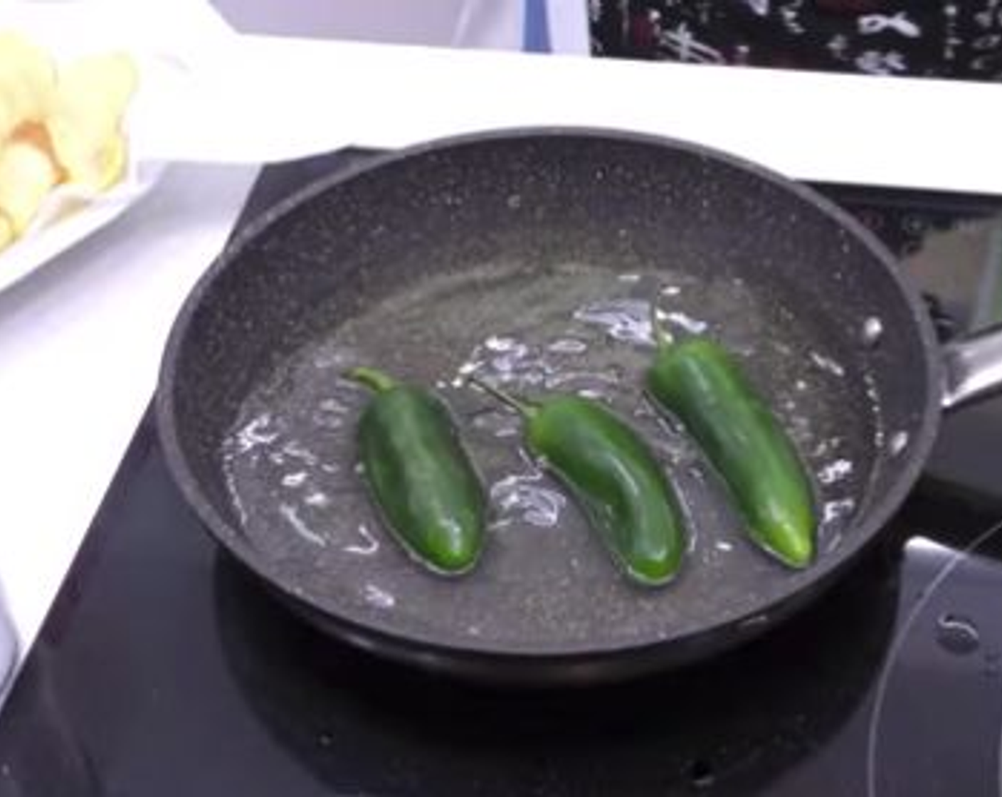 step 4 After you finish the potatoes, throw the Jalapeño Peppers (4) into the same oil to fry with the lid on until dark brown and starting to look shriveled. The lid prevents splatter in case one of the peppers pops open.