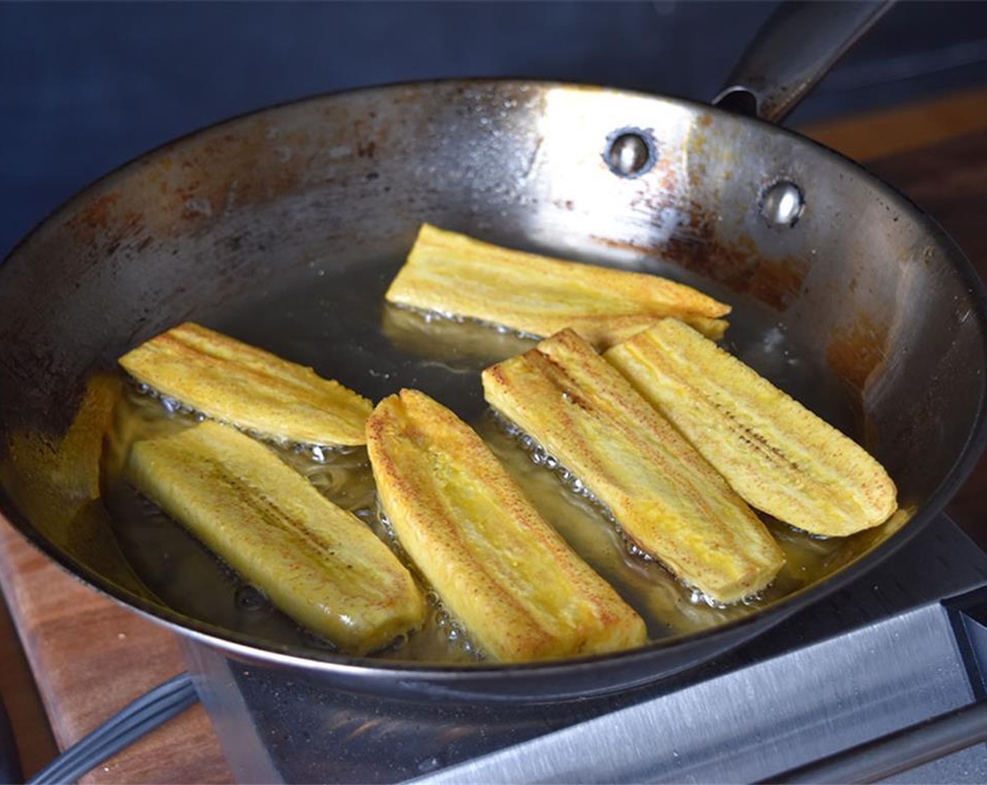 step 8 Heat Vegetable Oil (1/4 cup) in pan under medium heat. Fry the Plantains (4) on each side for 3-5 minutes or until golden brown. Drain on paper towels.