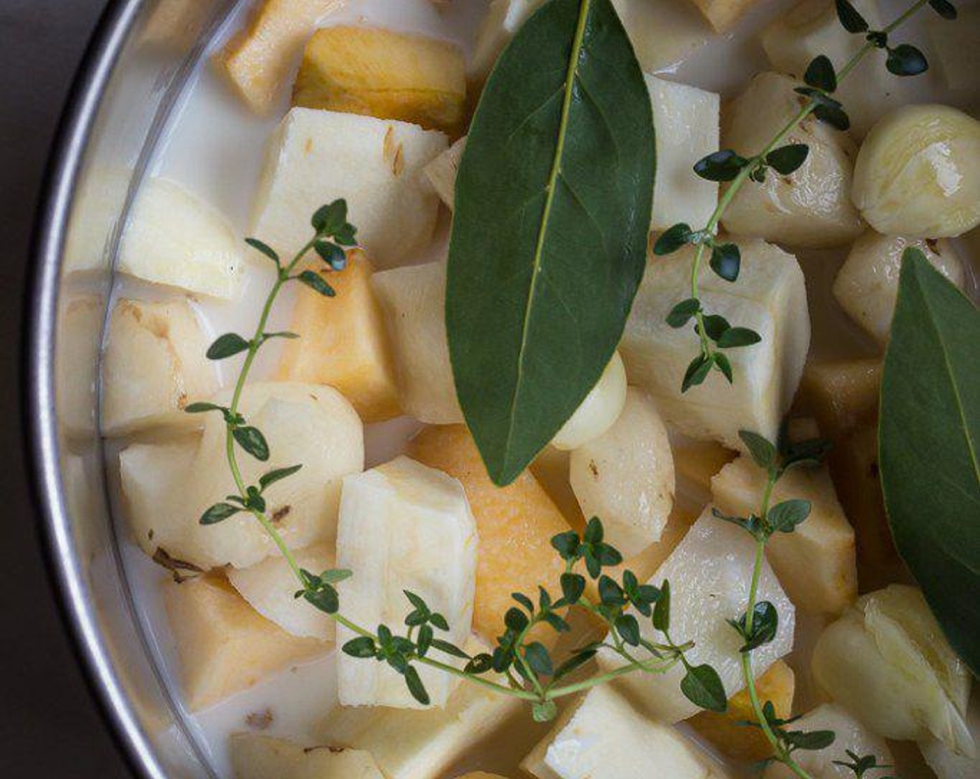 step 1 Add Parsnips (4), Golden Delicious Apples (2), Jerusalem Artichokes (2 1/4 cups), Garlic (2 cloves), Whole Milk (2 cups), Fresh Thyme (3 sprigs), Bay Leaves (2) and a couple of pinches of  Salt (to taste) to a medium pot and bring to a simmer.