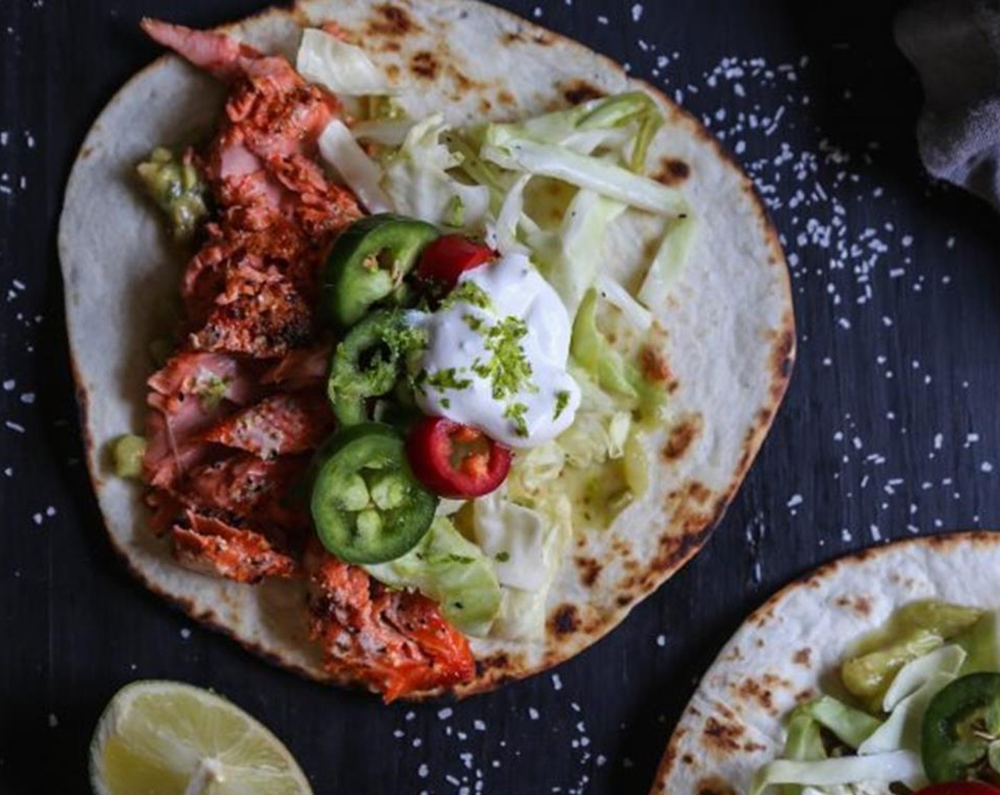 step 7 To serve, take some of the sockeye and place it into a Flour Tortillas (to taste) and top with the crema, Napa Cabbage (to taste), Jalapeño Peppers (to taste), Guacamole (to taste), or whatever toppings you desire!