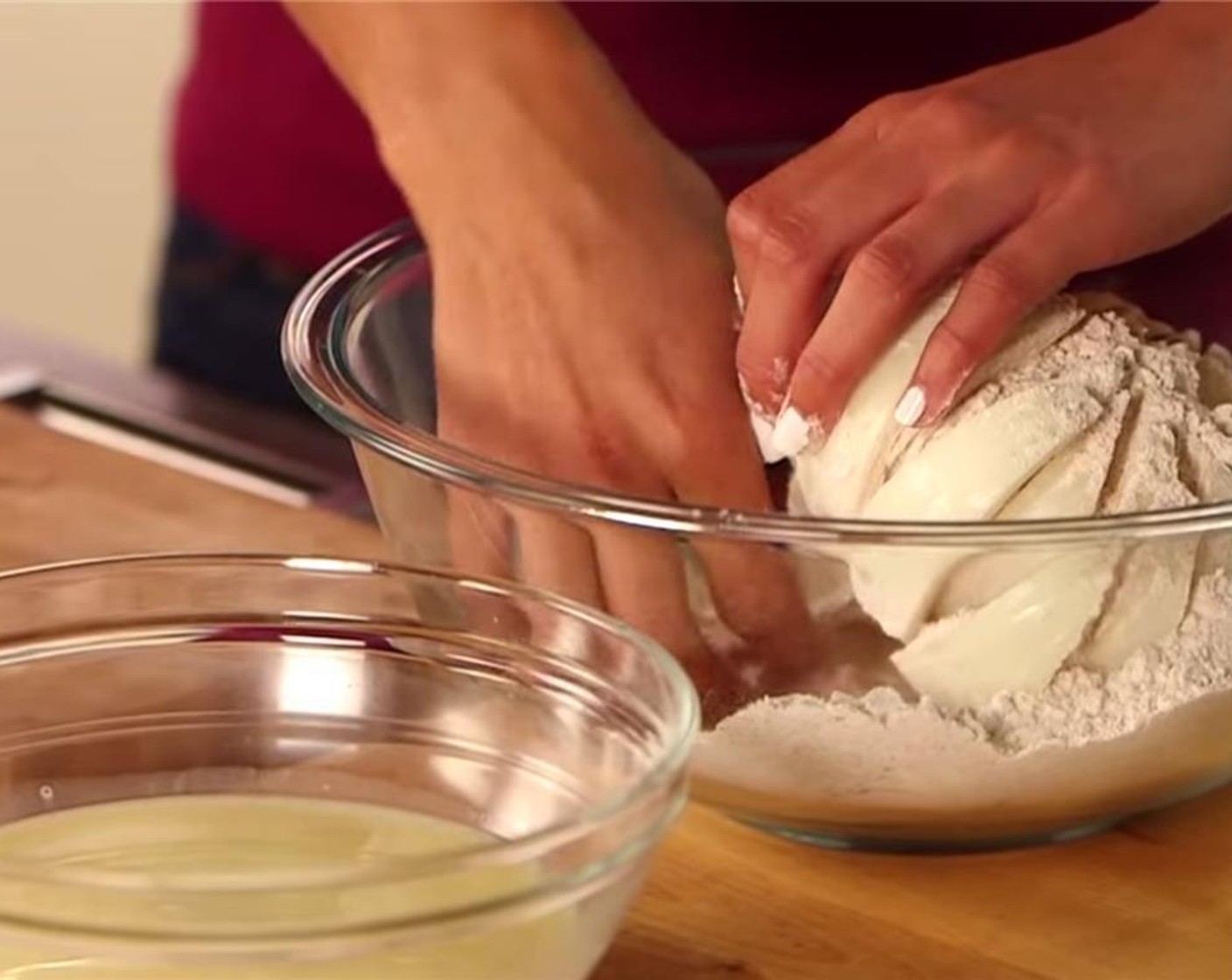 step 4 Place the onion cut-side down in the bowl, cover with a plate, and shake to coat onion and each "petal."