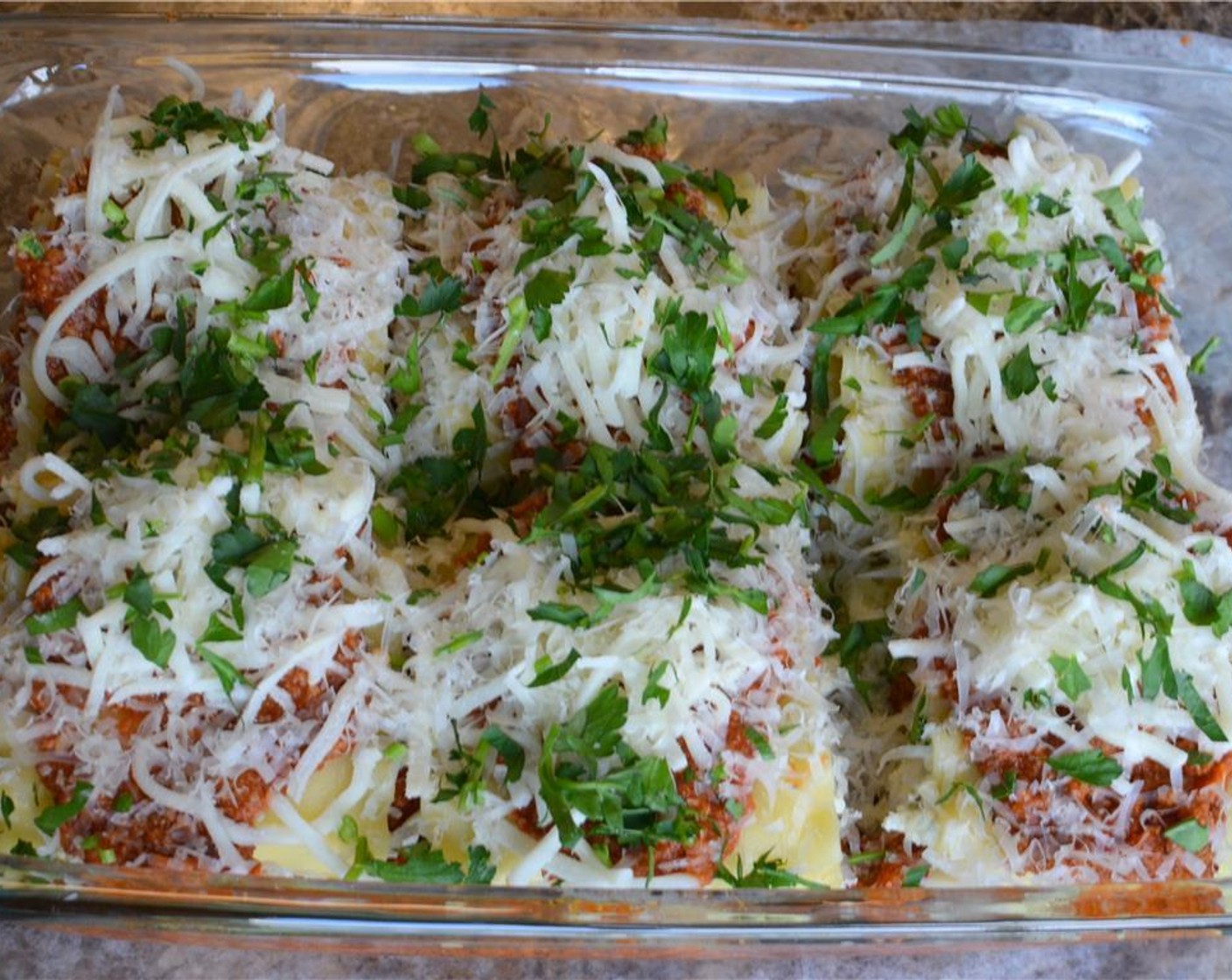 step 14 Spread the remaining Mozzarella Cheese (1/2 cup), Parmesan Cheese (1/2 cup), and Italian Flat-Leaf Parsley (1 handful) evenly over the top. Cover the dish with foil making sure it's not touching the cheese at all and bake at 375 degrees F (190 degrees F) for 35-40 minutes.
