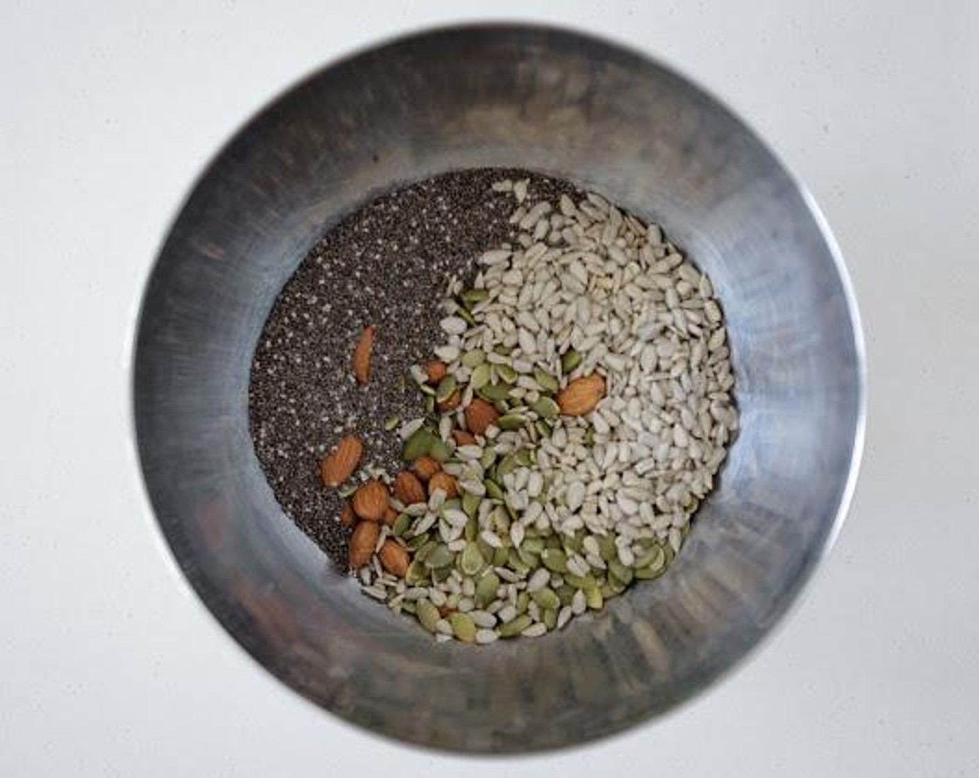 step 2 Add Almonds (1/2 cup), Pepitas (1/2 cup), Sesame Seeds (1/2 cup), Sunflower Seeds (1/4 cup), Chia Seeds (1/4 cup), and Pink Himalayan Sea Salt (1 tsp) to a medium mixing bowl.